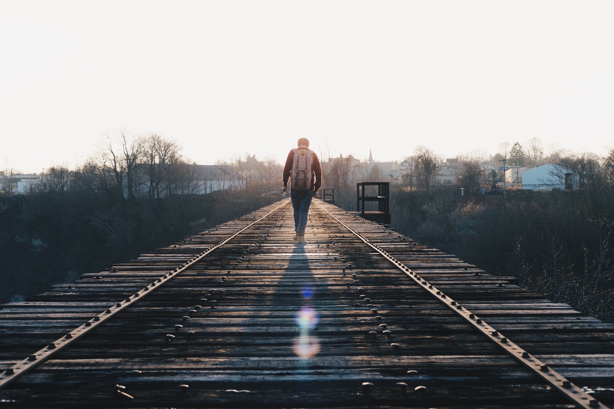a man wearing a backpack walking across a railroad bridge in rochester, rochester railroad bridge 4k, HD Wallpaper