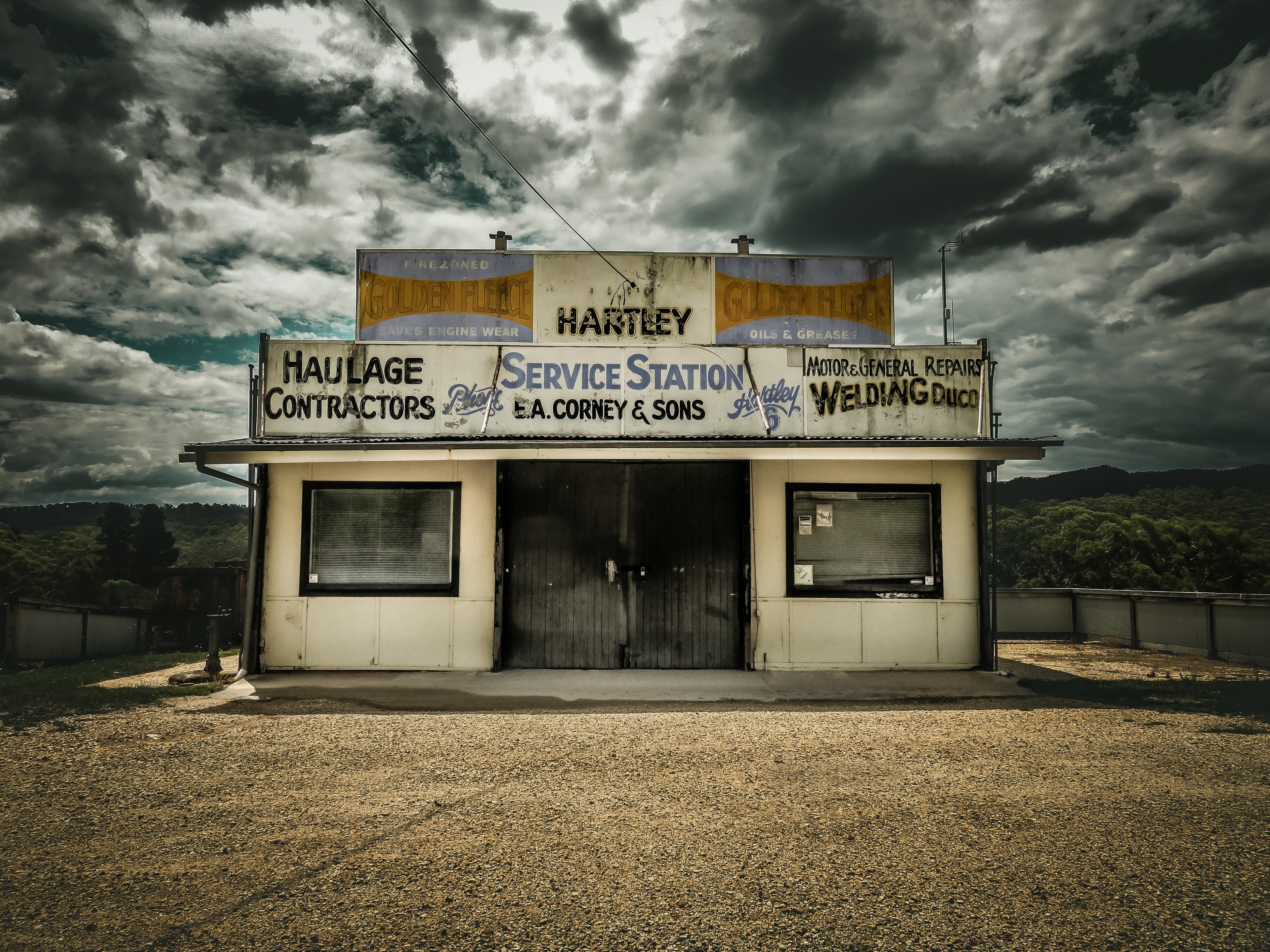 a small car service station at the roadside under a cloudy sky, small service station 4k, HD Wallpaper