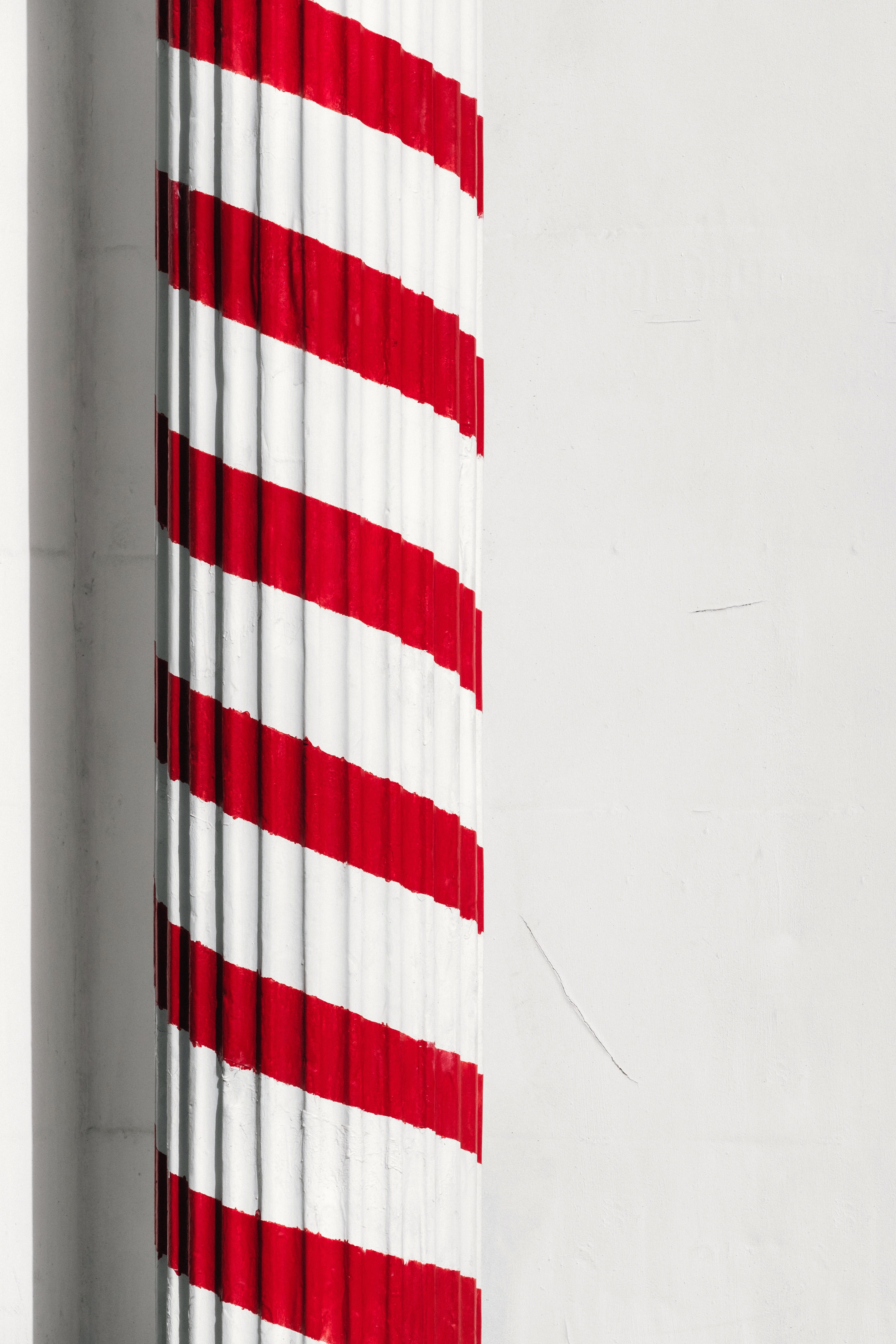 a greek column painted in red in front of a barber 4k, Phone HD Wallpaper