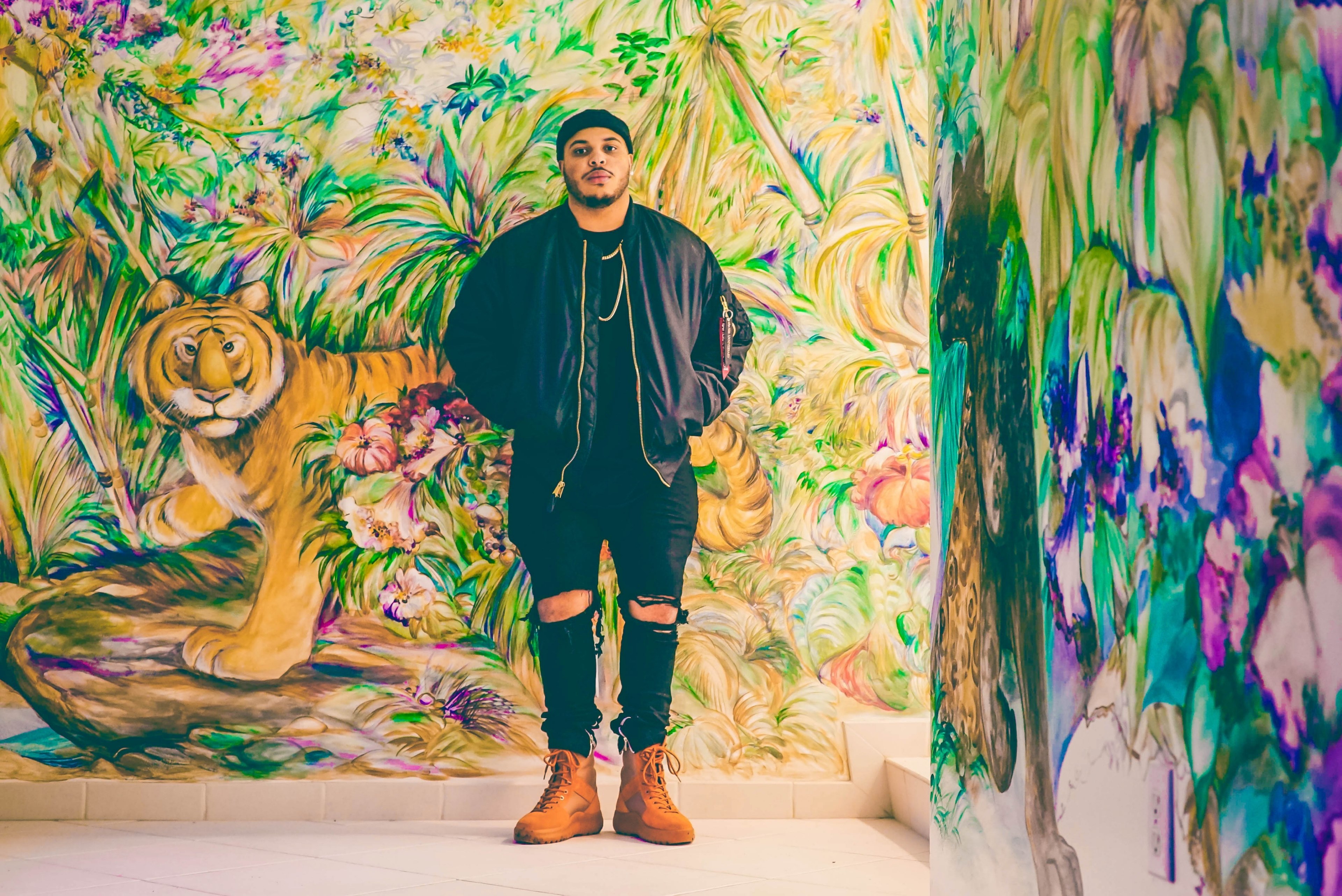 man standing in front on a colorful mural of a tiger and jungle flowers, the jungle 4k, HD Wallpaper