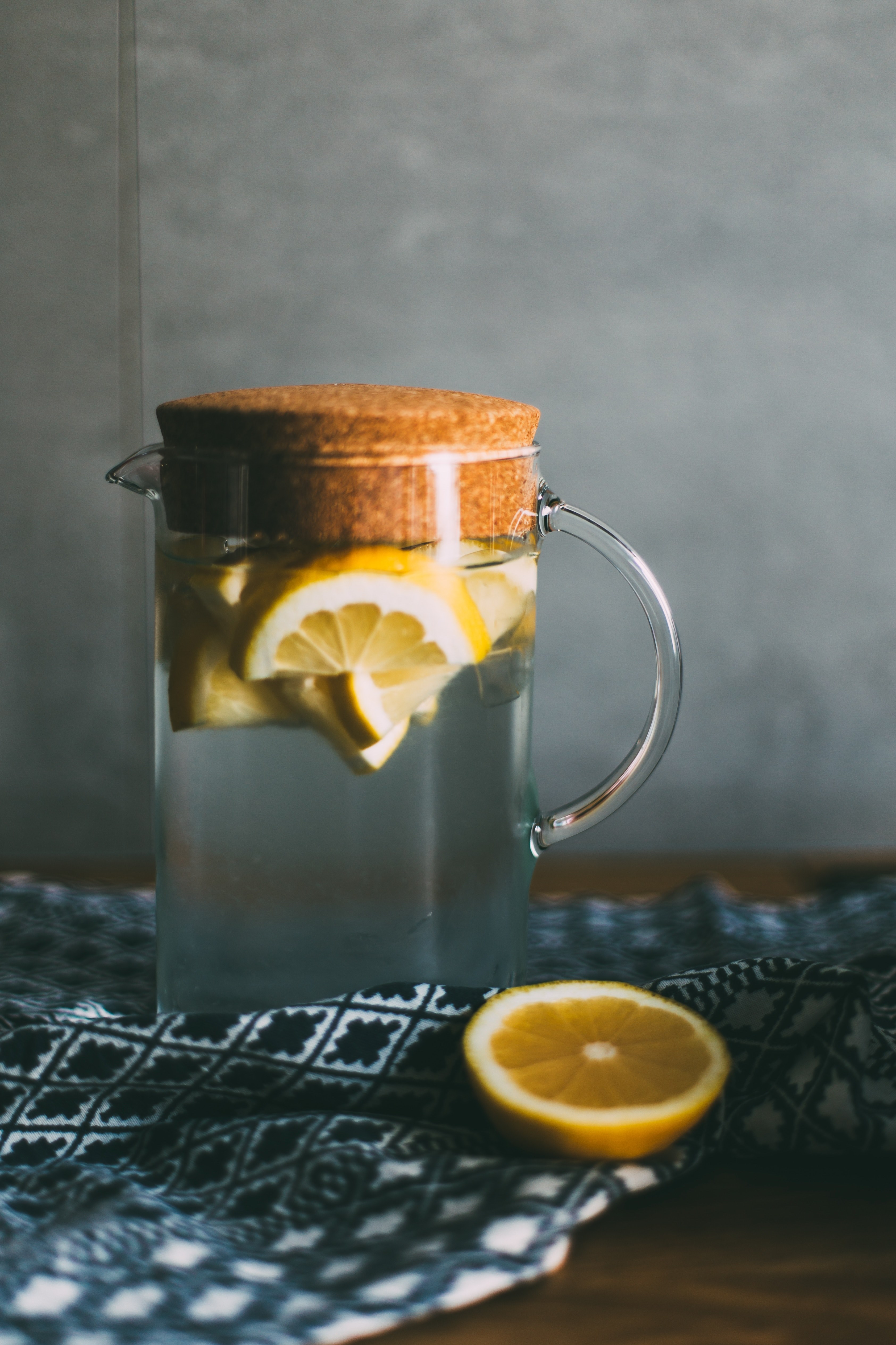 a glass jug with water and slices of lemon on a tablecloth, lemons in a water jug 4k, Phone HD Wallpaper
