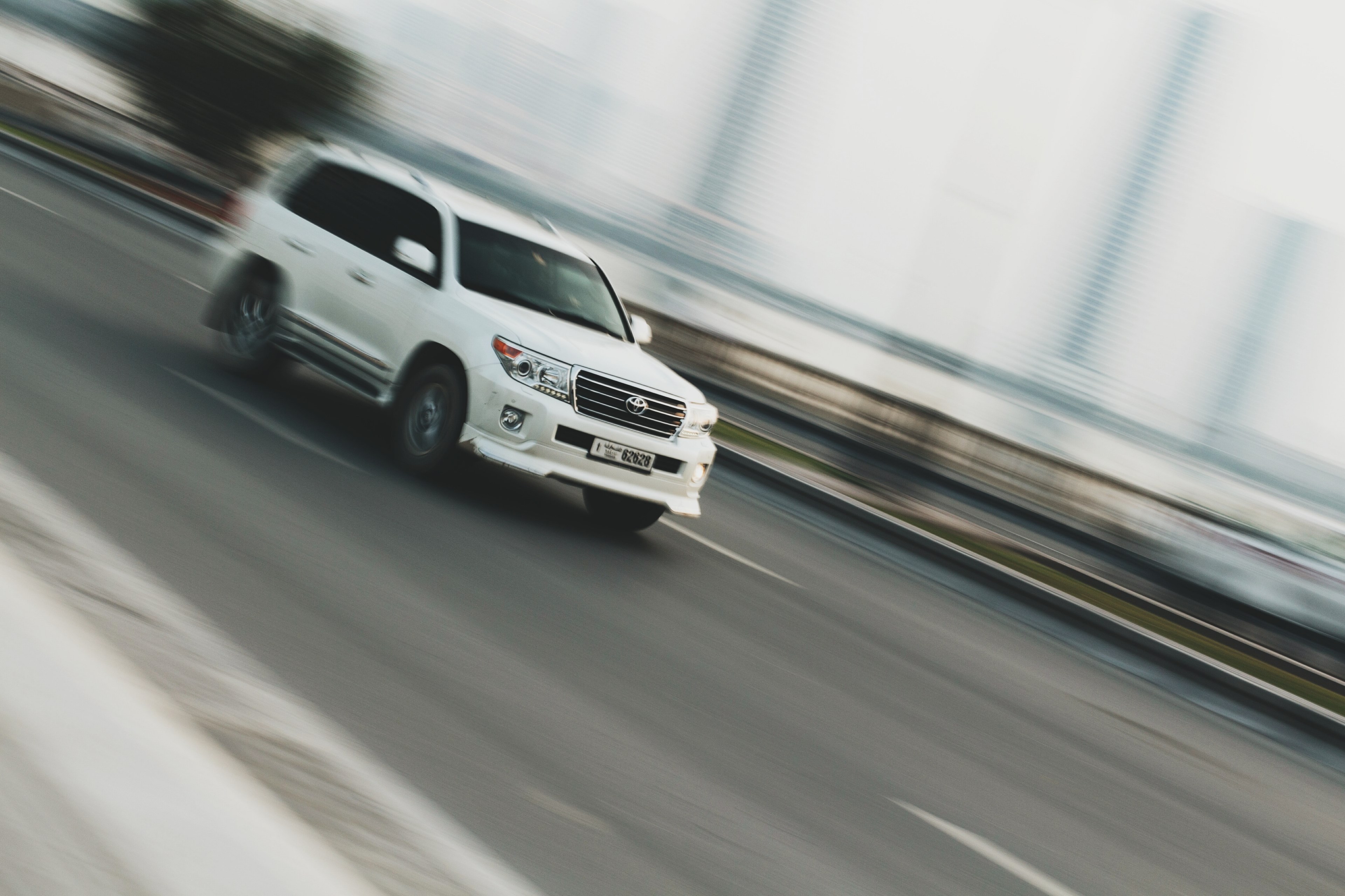 a blurry shot of a white suv driving on a road in al qasba, pride of the highway 4k, HD Wallpaper