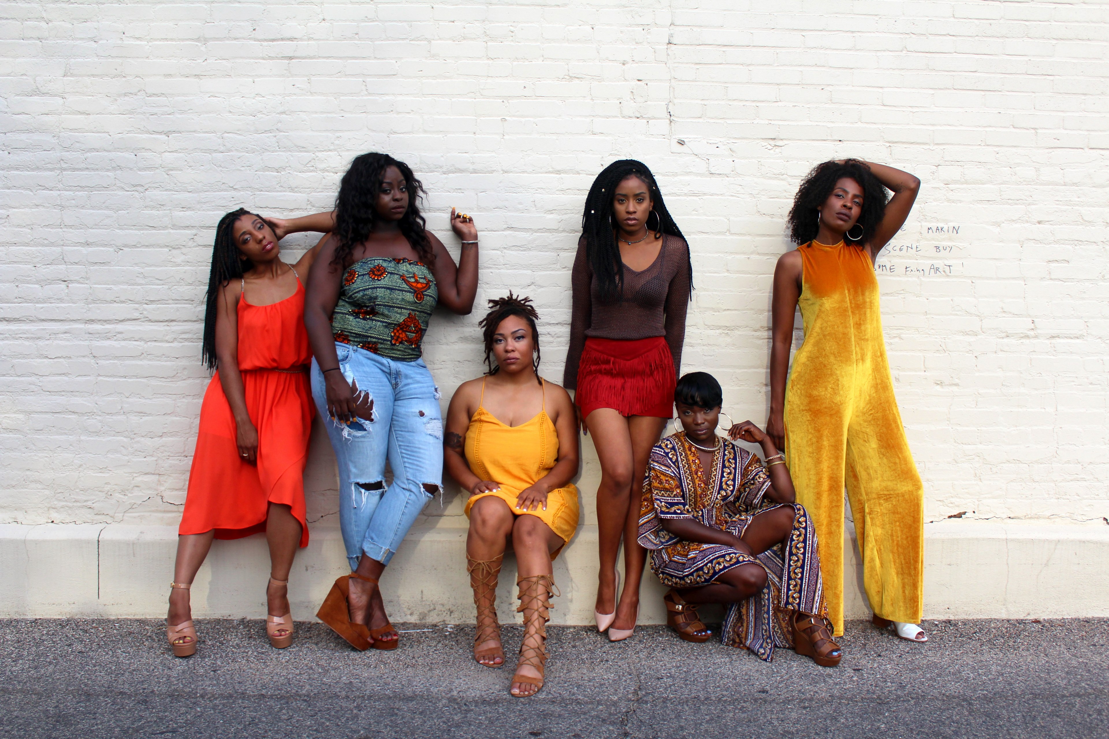 group of women standing and sitting against a white brick wall on the sidewalk in uptown, reflecting queens 4k, HD Wallpaper