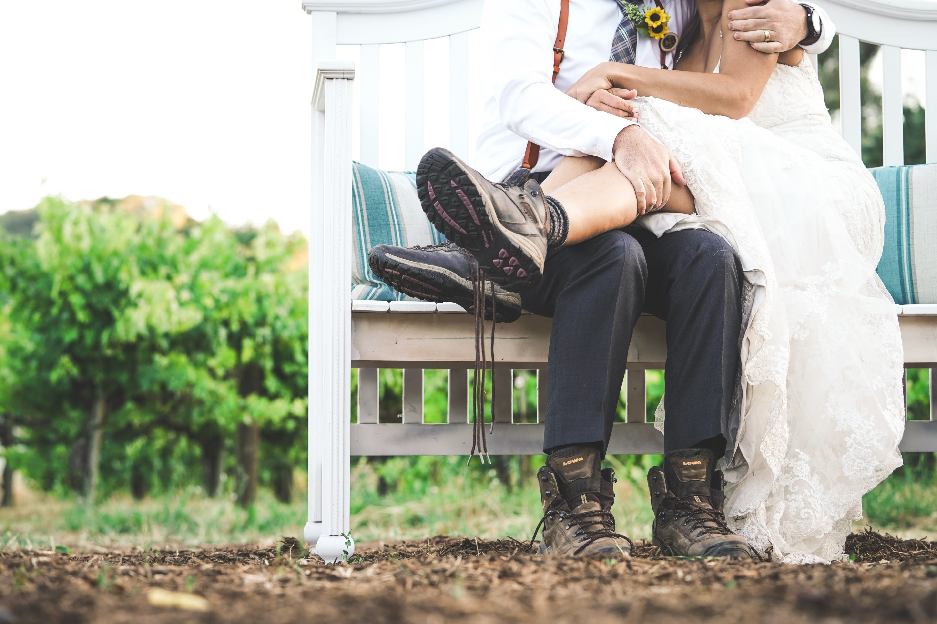 in sonoma a groom holds bride on white bench with both wearing hiking boots, hitched hike 4k, HD Wallpaper