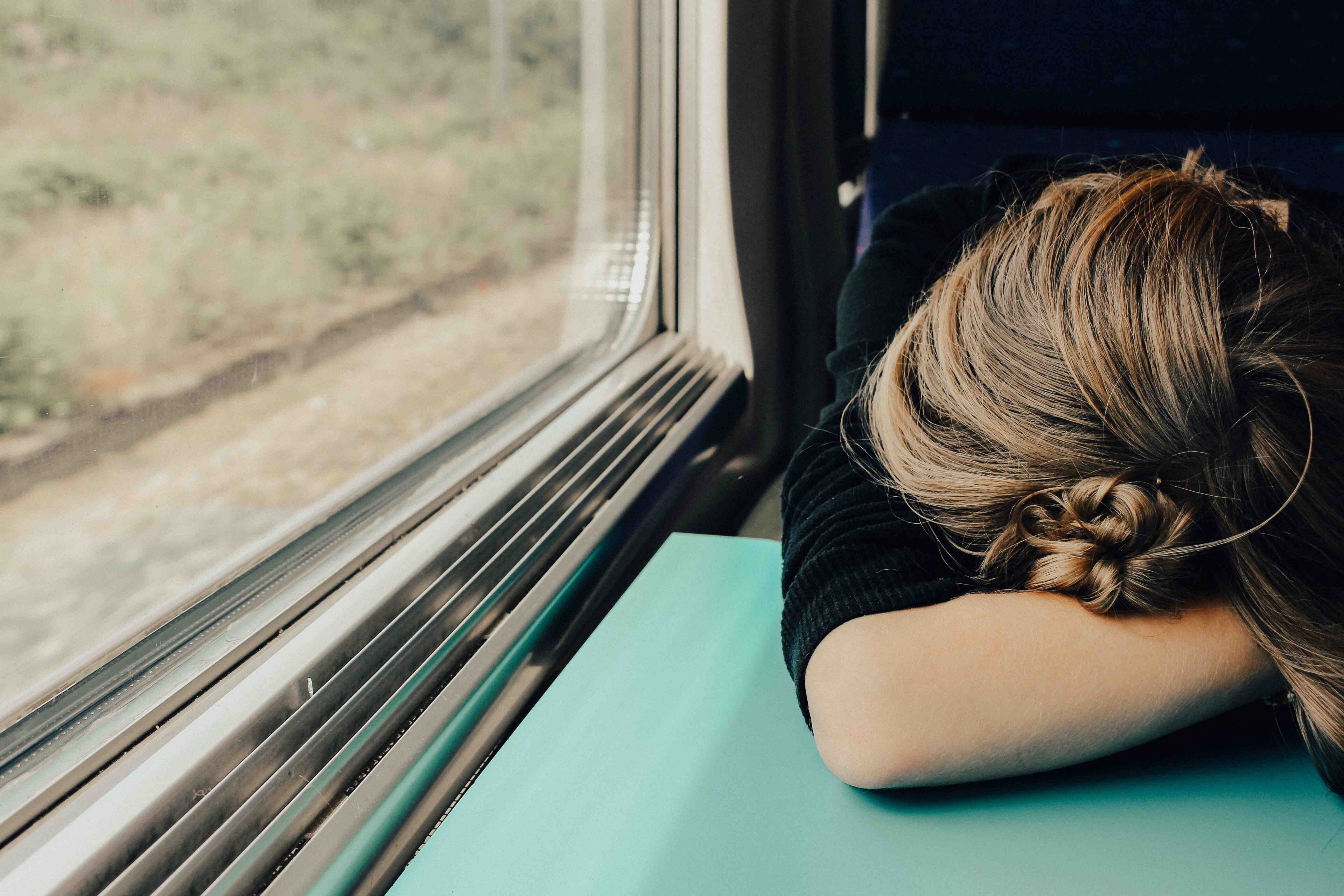 tired woman with her head down on a train tray table, travel jet lag 4k, HD Wallpaper