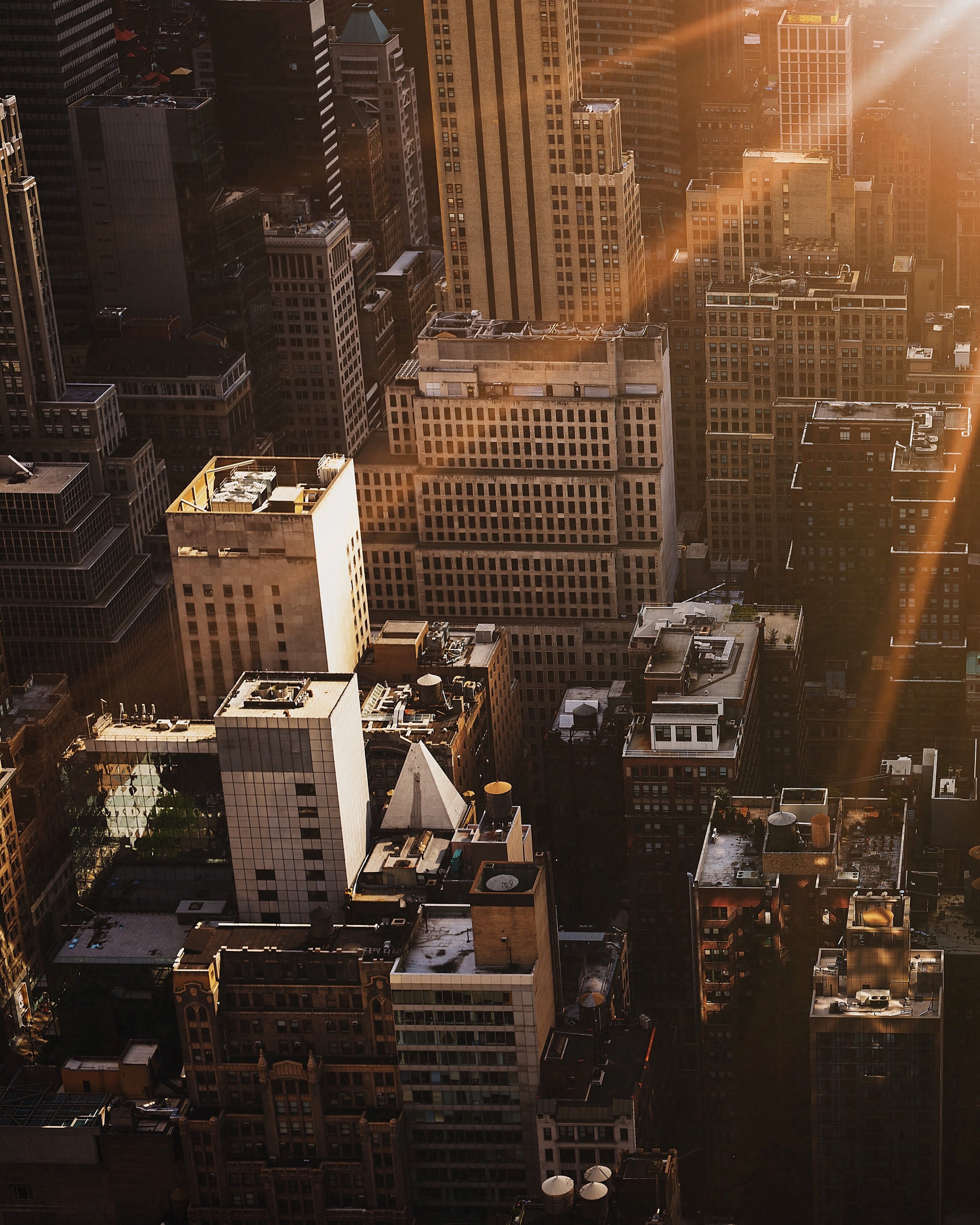 a look down on new york city from top of the rock in manhattan during golden hour, suns rays shine on nyc 4k, Phone HD Wallpaper