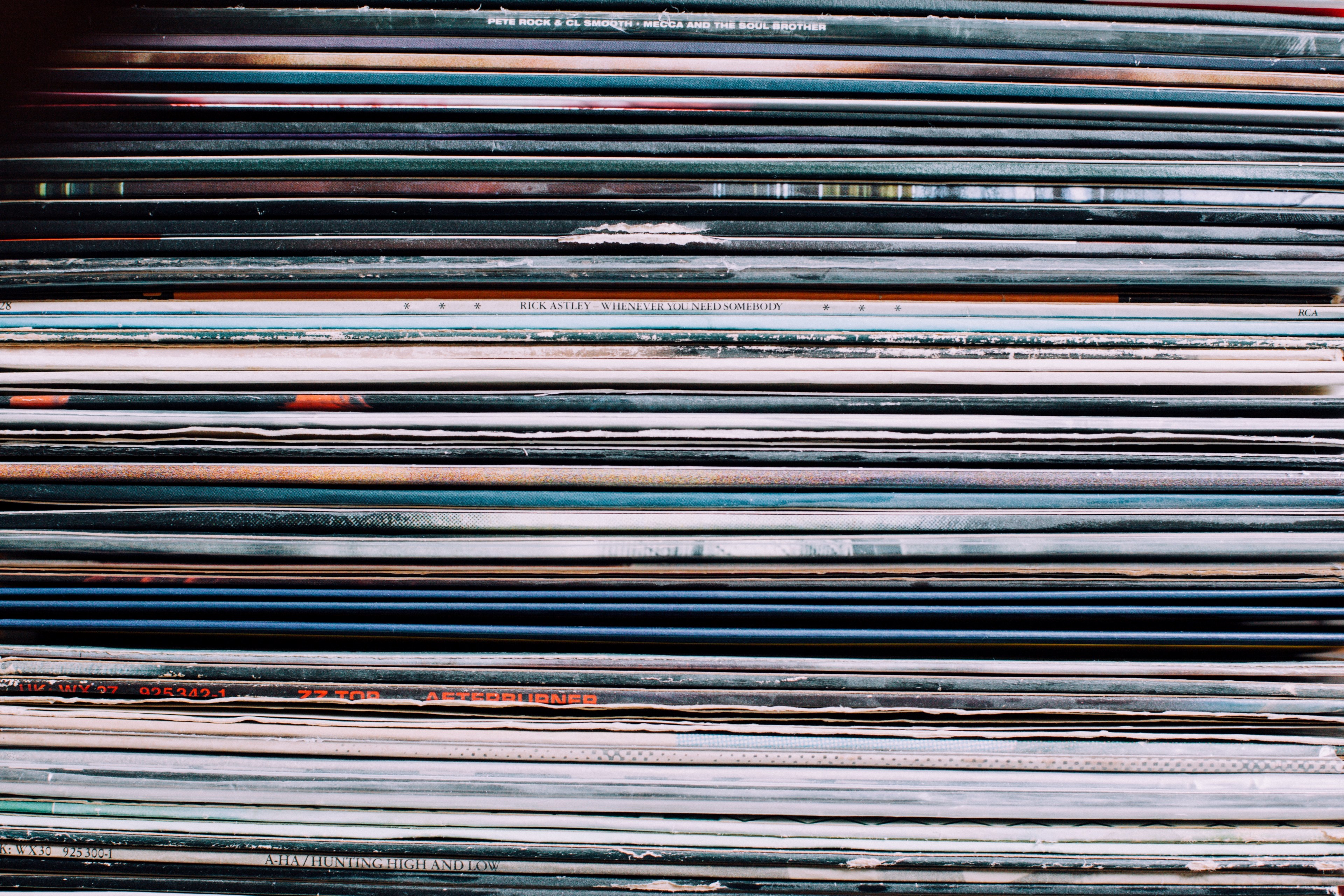 a background consisting of a stack of records in the city of nancy france, nancy record label shop items 4k, HD Wallpaper