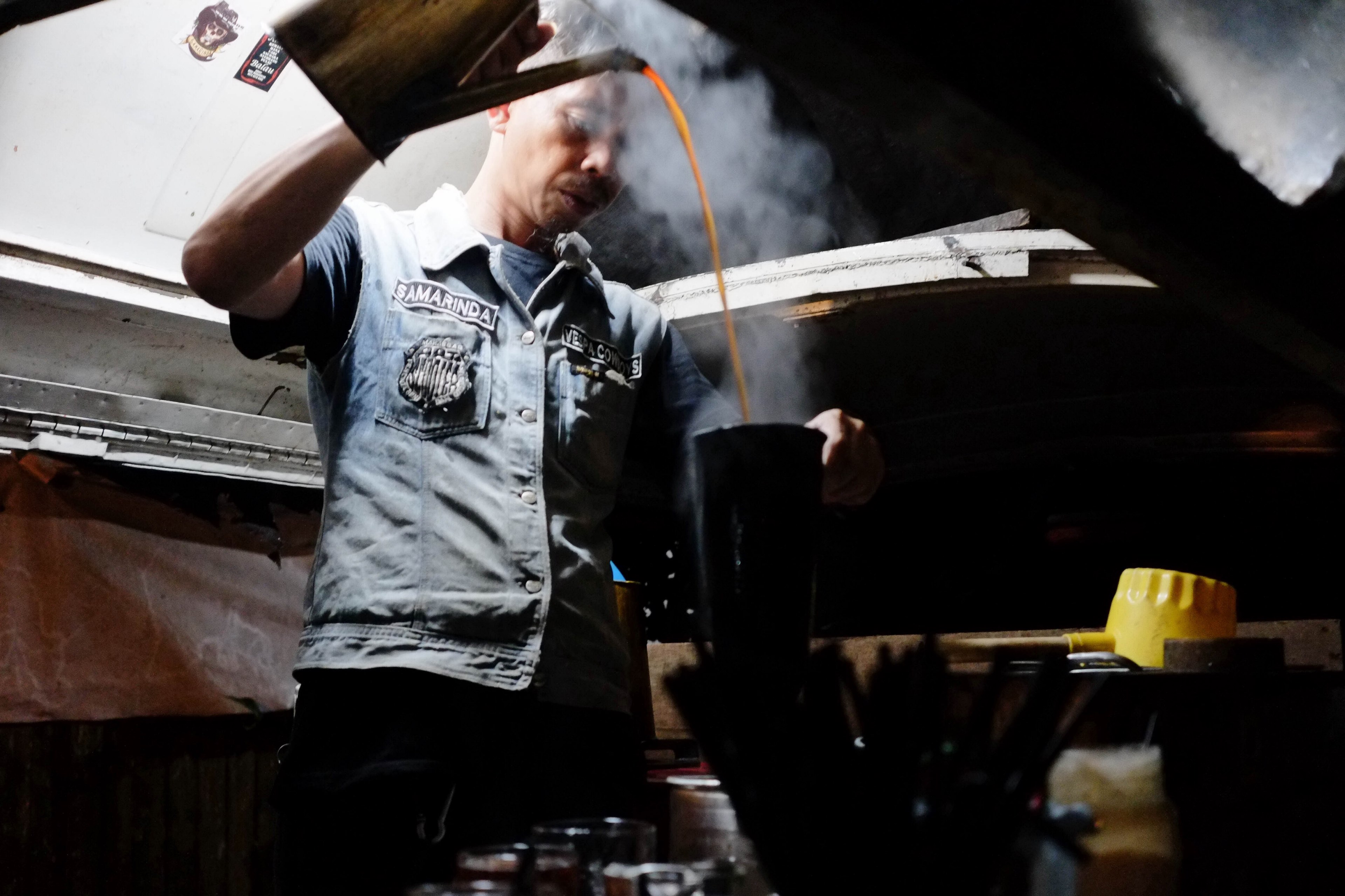 a man in a jean vest pours steaming coffee from a kettle in samarinda, the waterfall of a coffee 4k, HD Wallpaper
