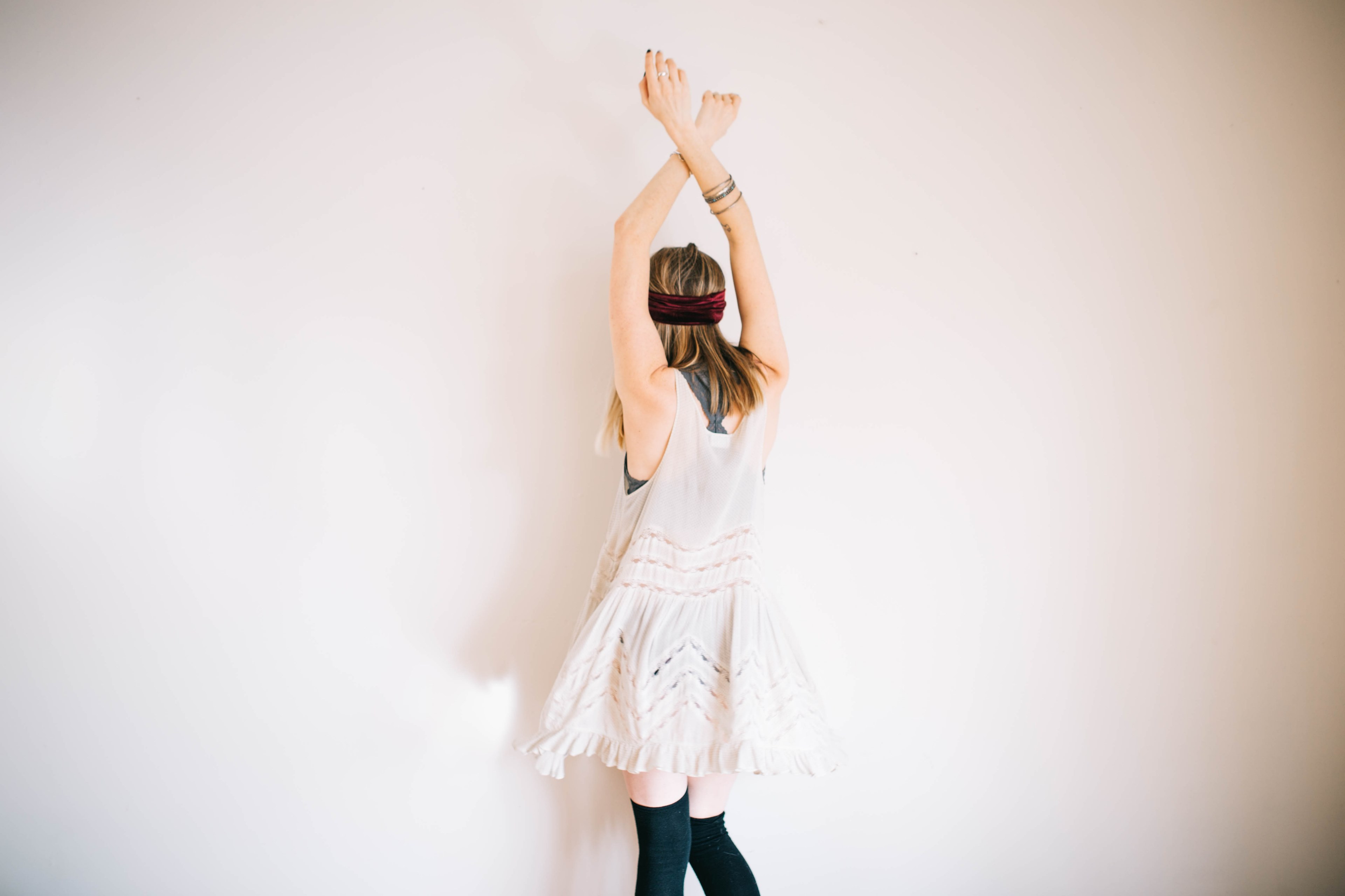 a woman in a white dress and black knee socks dancing near a wall, woman in a dress dancing alone 4k, HD Wallpaper