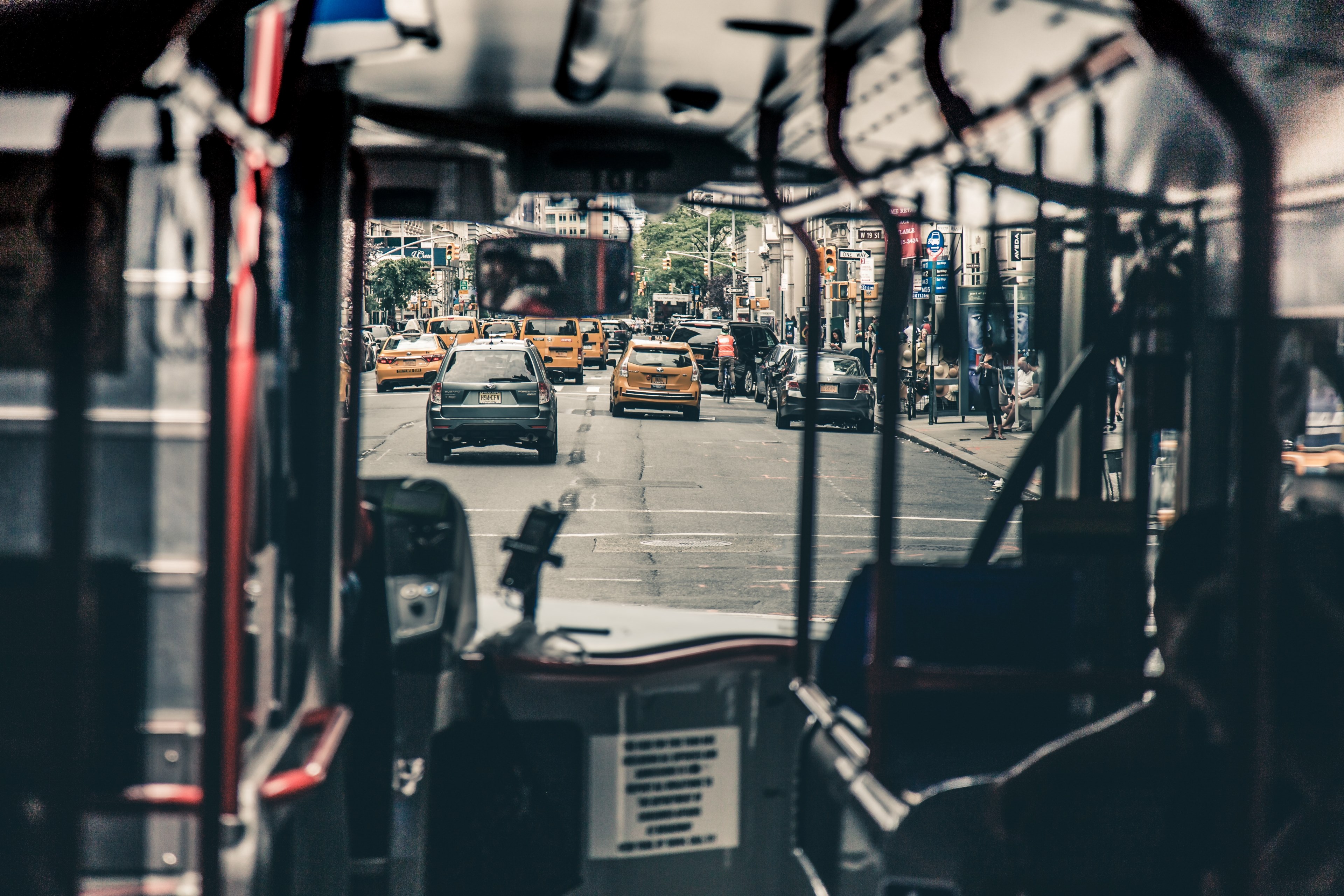a shot looking through a public bus through the windshield onto a street filled with cars and taxis, we dont take the bus often enough 4k, HD Wallpaper