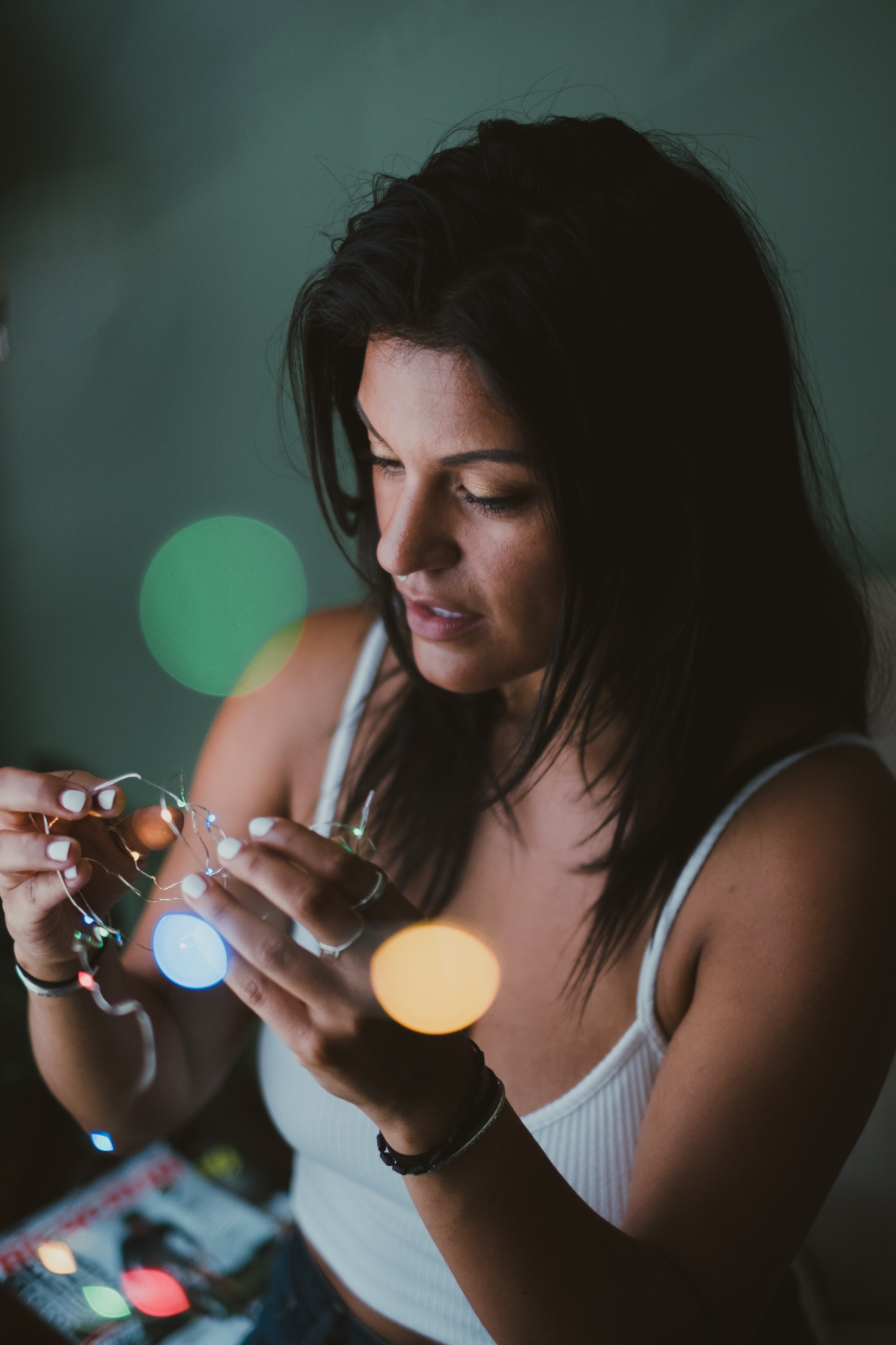 a woman in a white spaghetti strap is working with wires with bokeh lights effect, _girl and the lights 4k, Phone HD Wallpaper