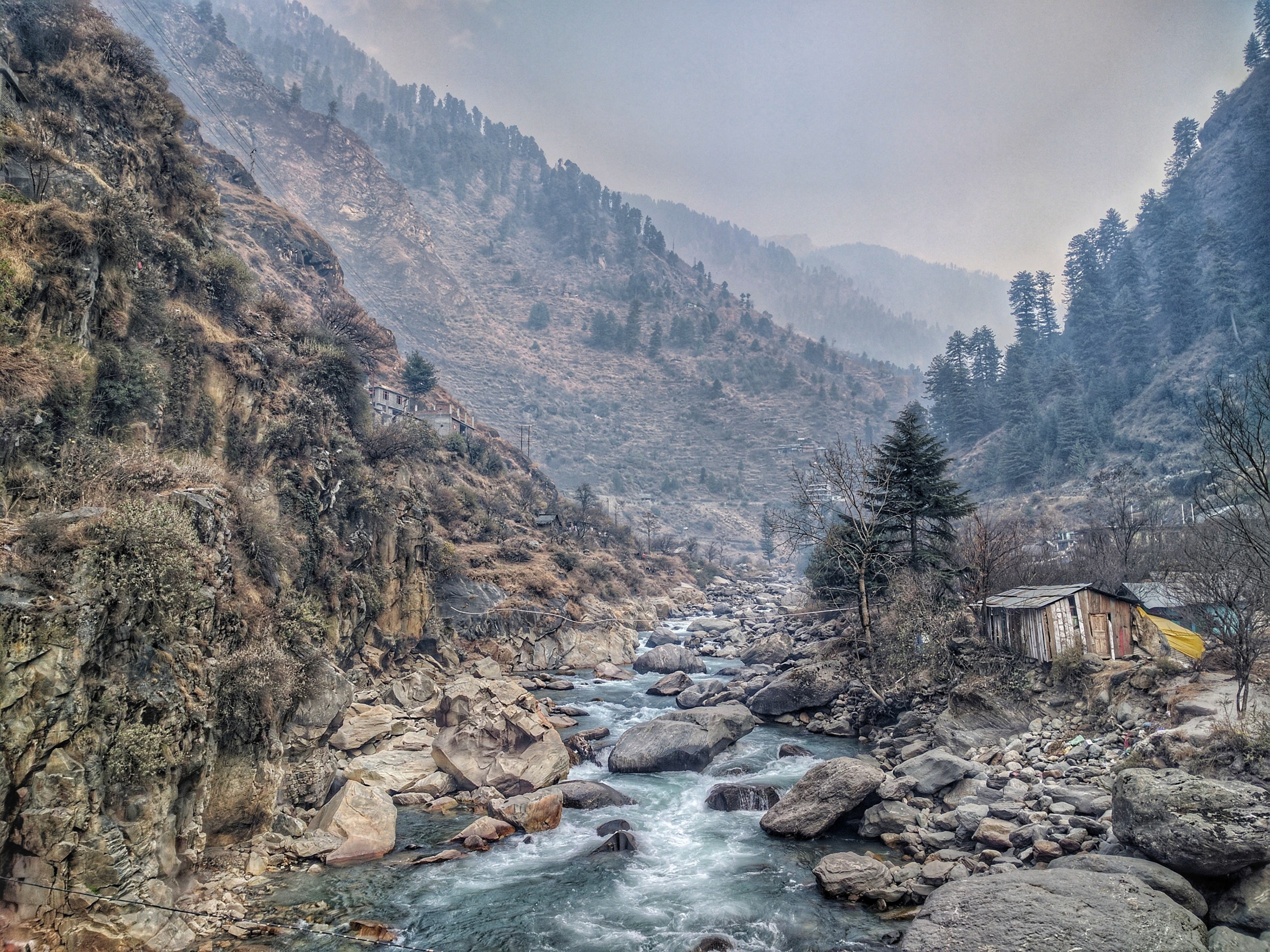 a creek flowing between wooded hills next to wooden shacks in india, creek among hills 4k, HD Wallpaper