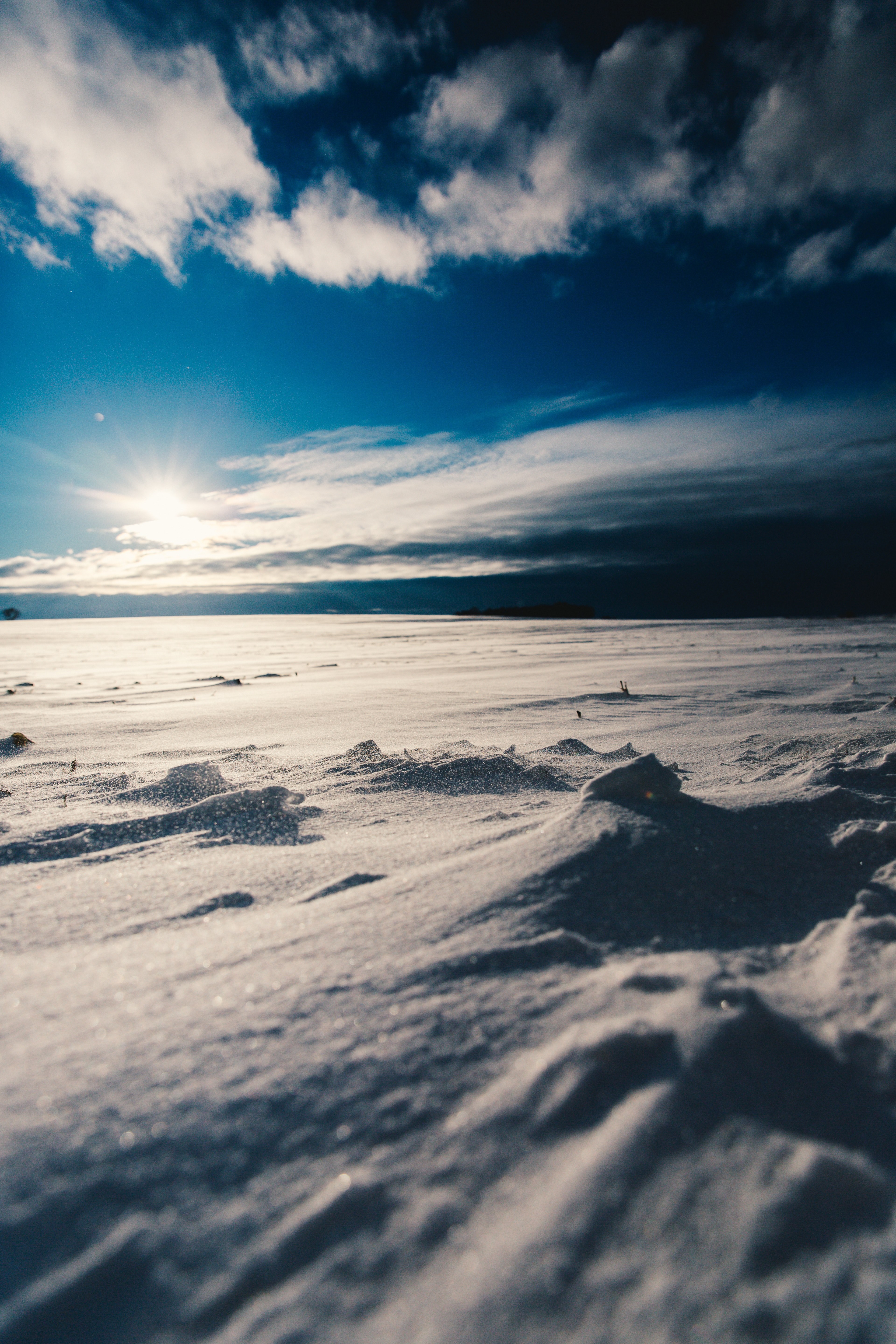 a blue sky in white clouds with white snow fall on the ground, a blue sky above white snow 4k, Phone HD Wallpaper