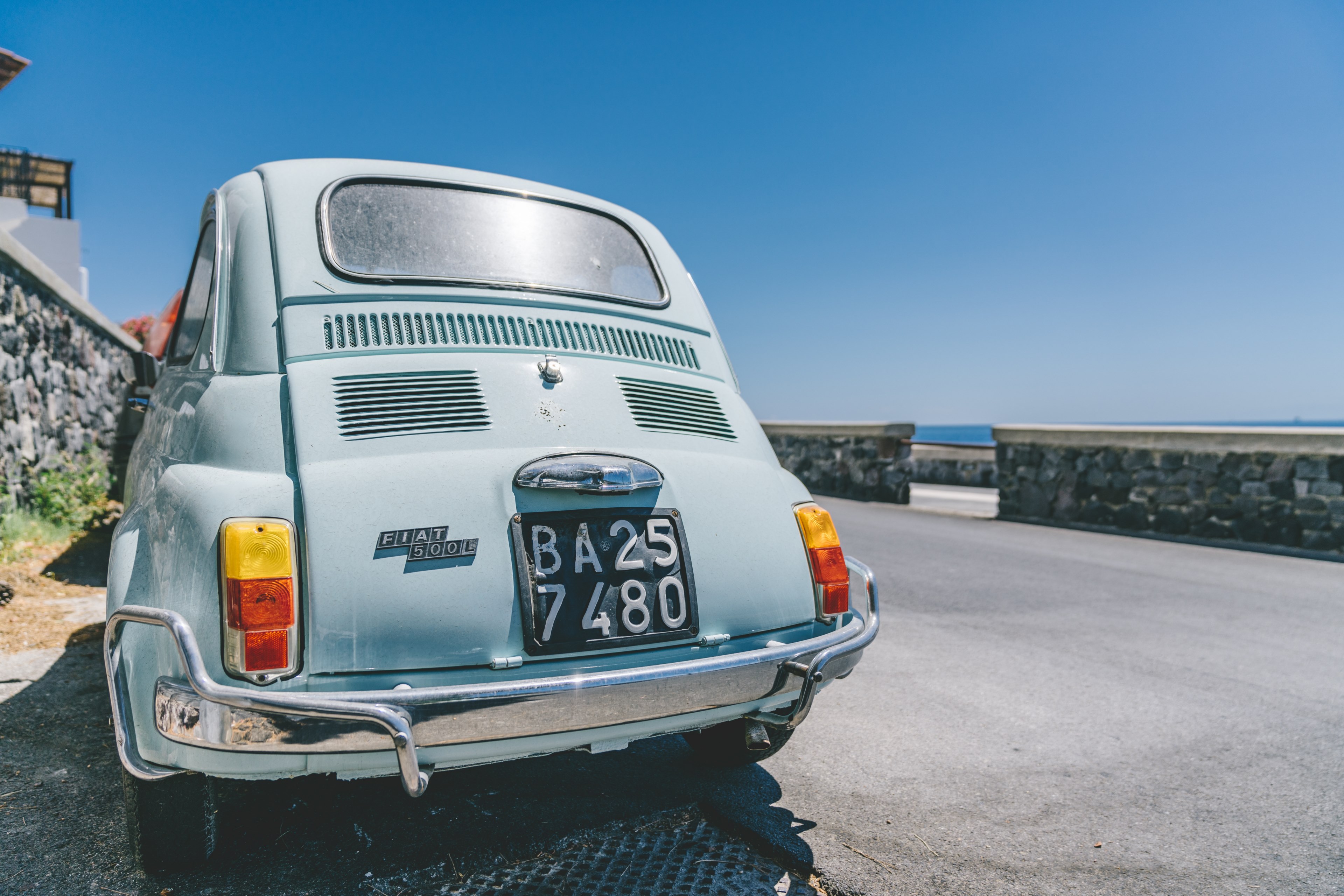 an old model of the fiat 500 is seen parked on a corniche road, _fiat 500 corniche road 4k, HD Wallpaper