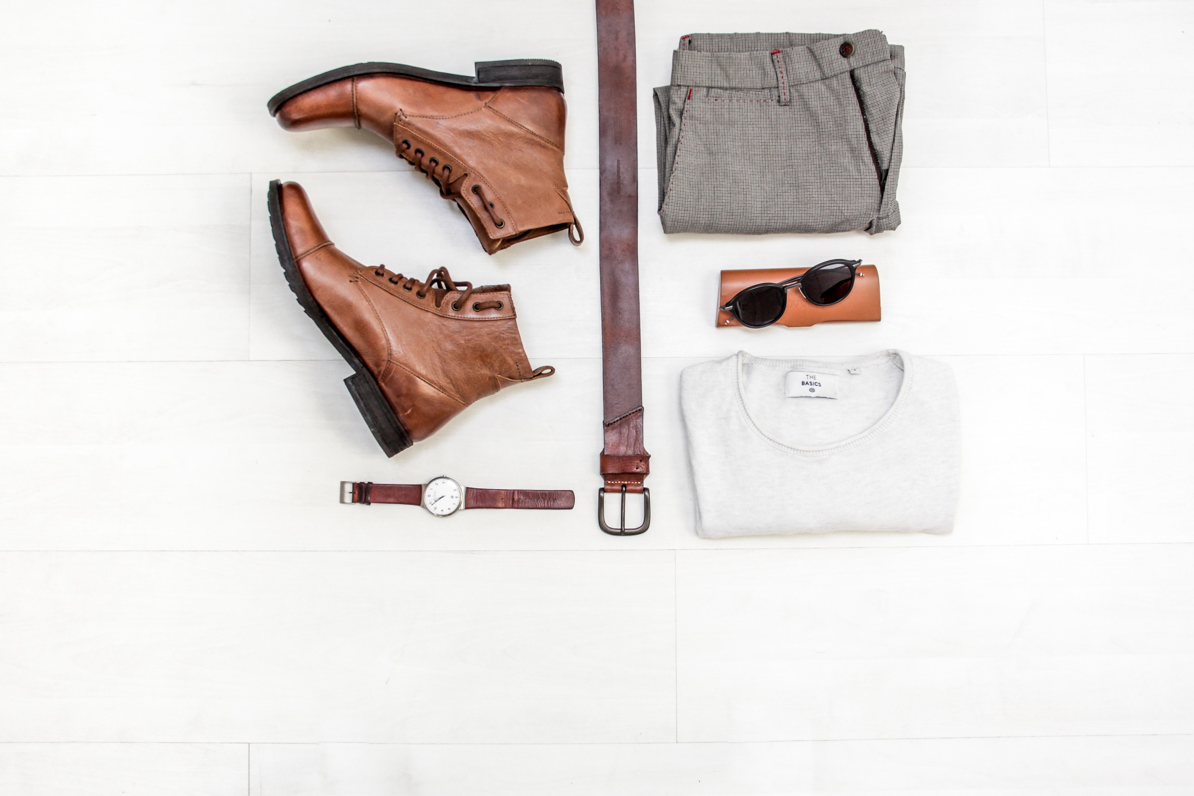 top down view of a pair of leather boots a leather belt a leather analogue watch grey slacks sunglasses and case and a white tee on a white surface, clothing flatlay 4k, HD Wallpaper