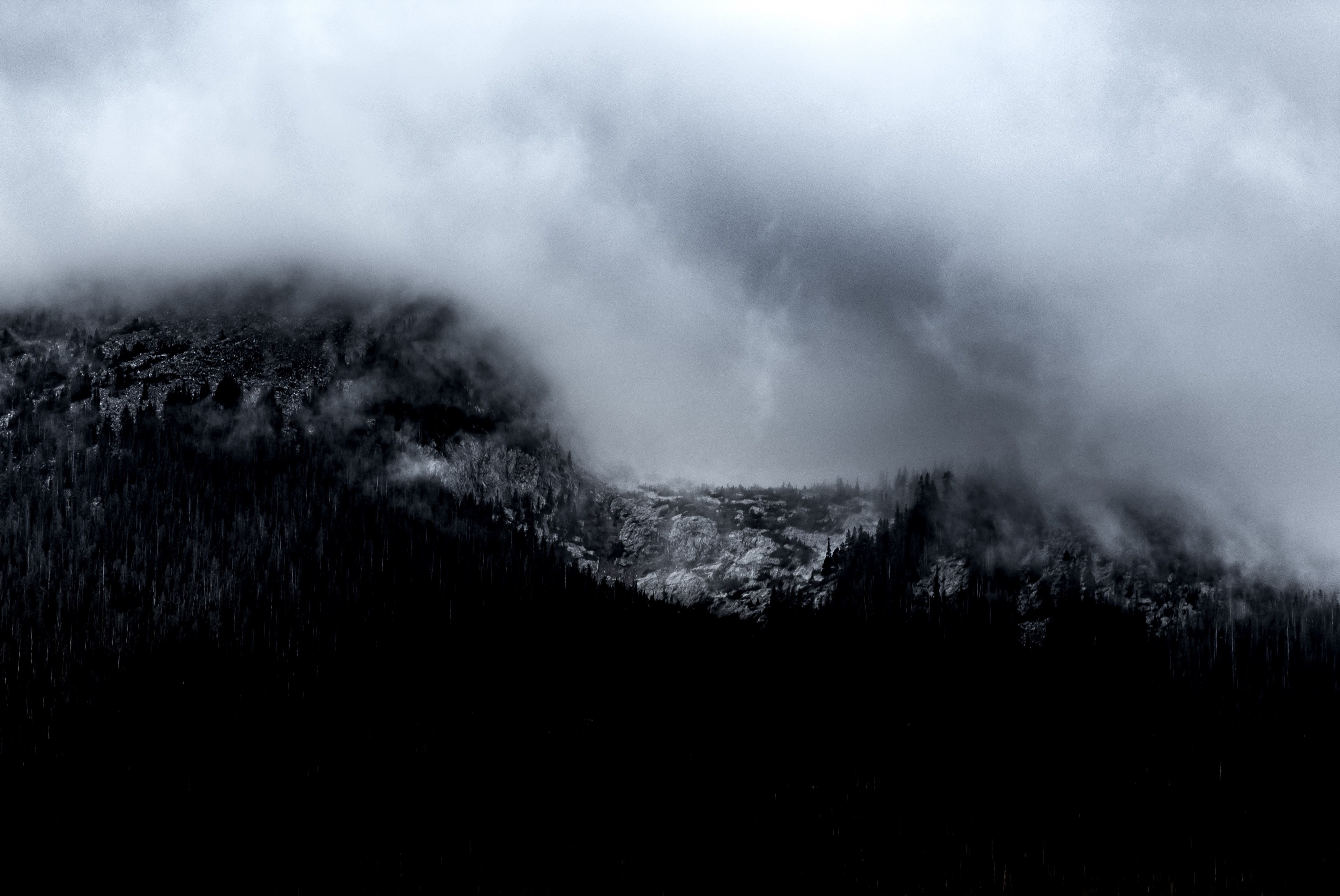 a desaturated shot of heavy clouds gathering over a mountain in silverthorne, clouds over gray mountains 4k, HD Wallpaper