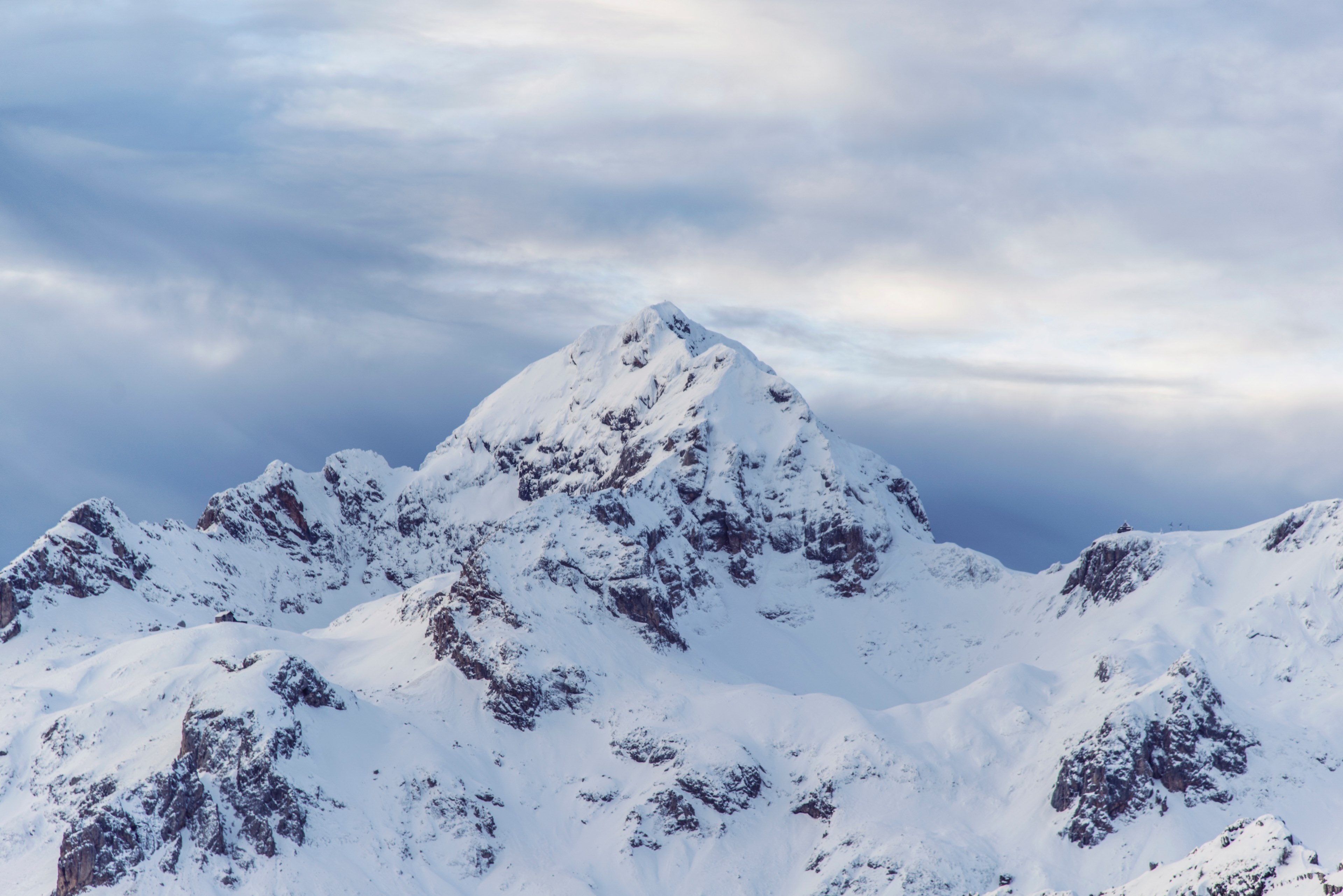 a rugged snow capped mountain summit against an overcast sky, alpine peak on a cloudy day 4k, HD Wallpaper