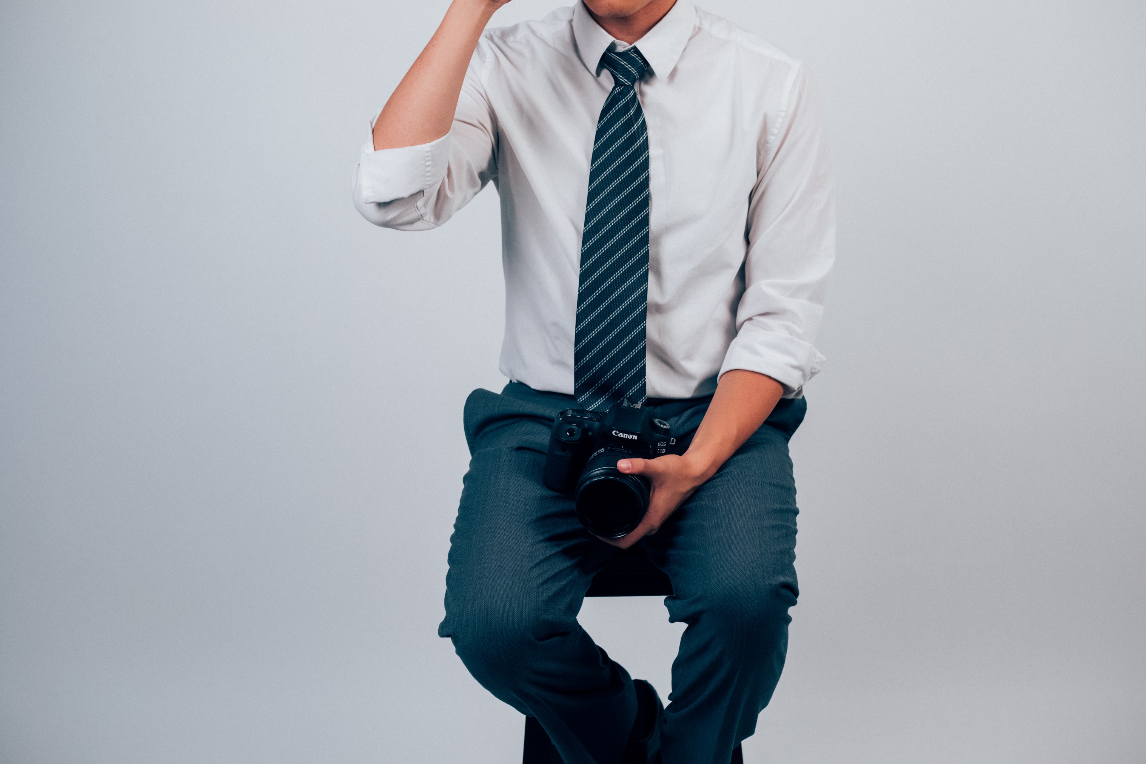 person in business clothes sitting on a stool holding a camera, business photographer 4k, HD Wallpaper