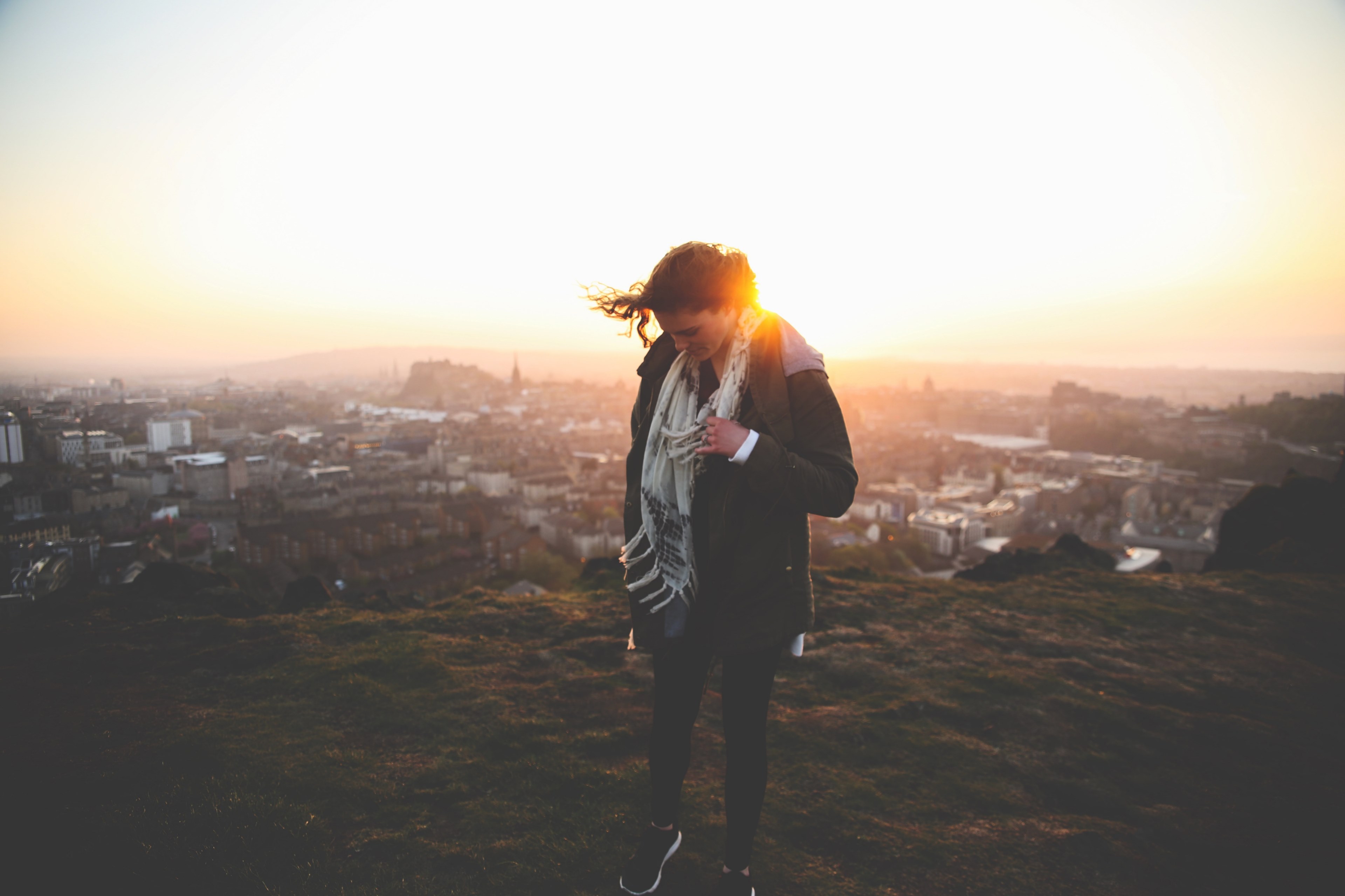 a woman with windswept bangs on a sunny hilltop overlooking the city of edinburgh, woman on hilltop 4k, HD Wallpaper