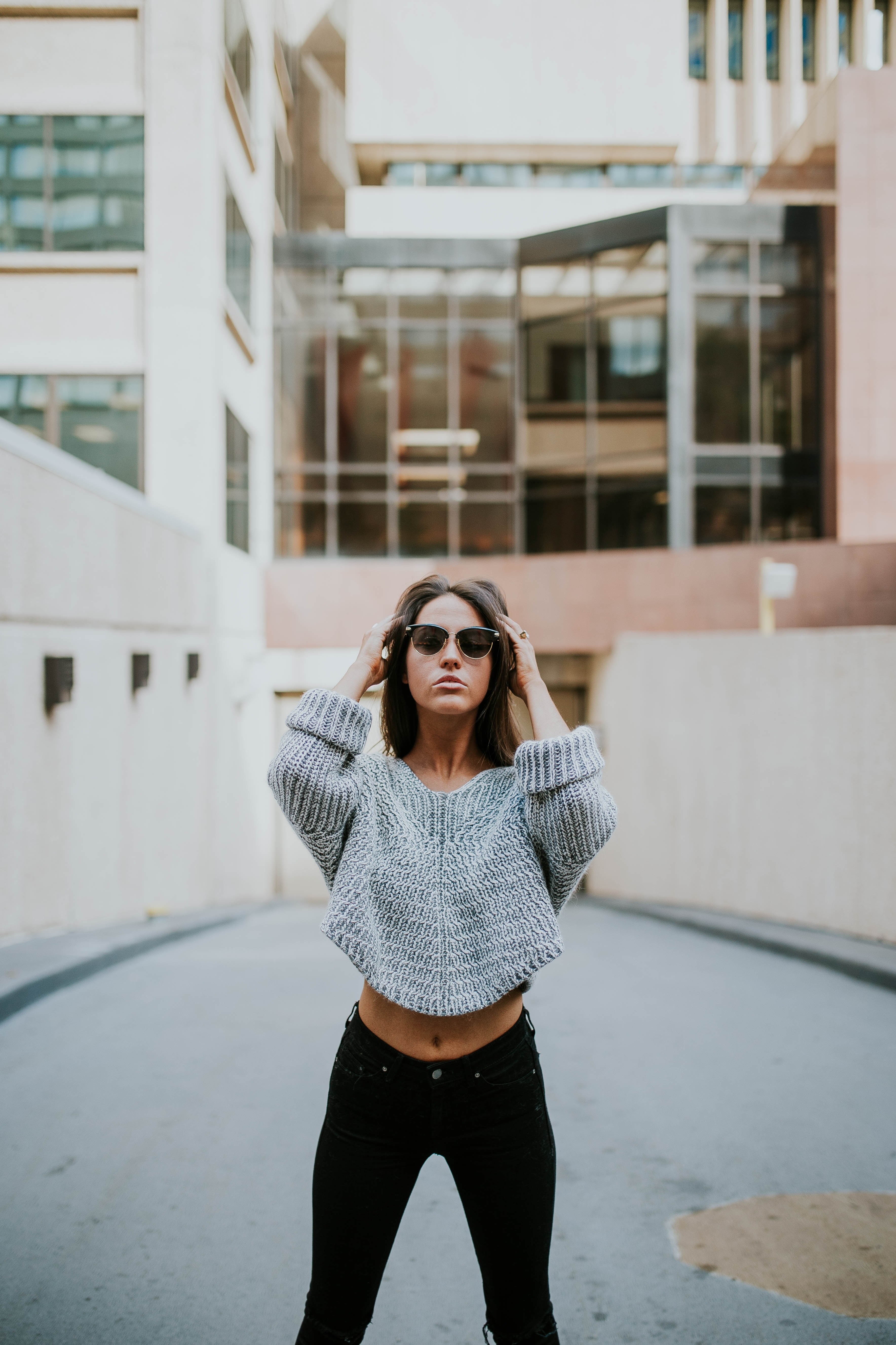 woman models a chunky knit sweater and sunglasses by office buildings, chunky knit sweater 4k, Phone HD Wallpaper