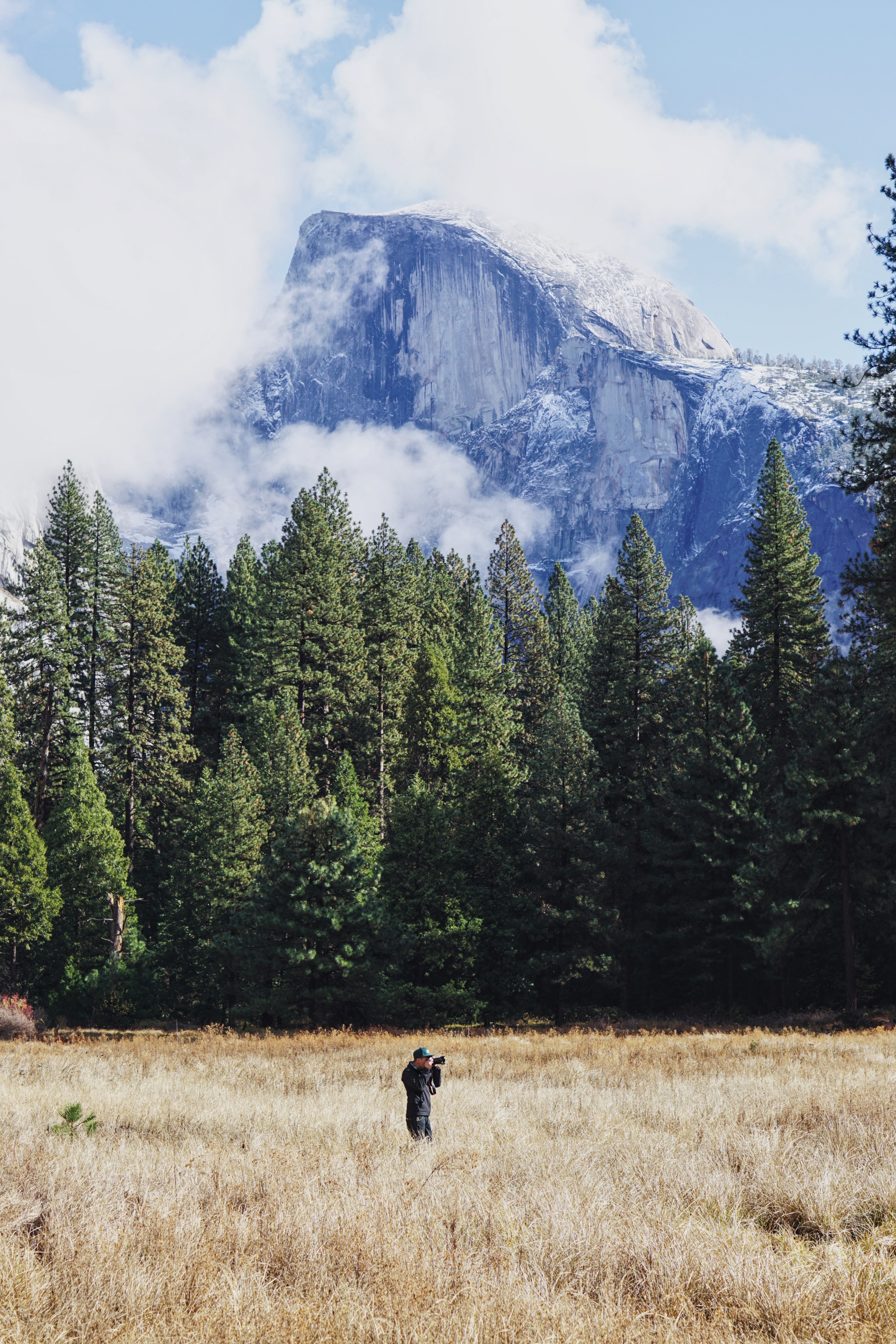 a photographer standing in a field with a view on yosemites half dome, photographer near half dome 4k, Phone HD Wallpaper