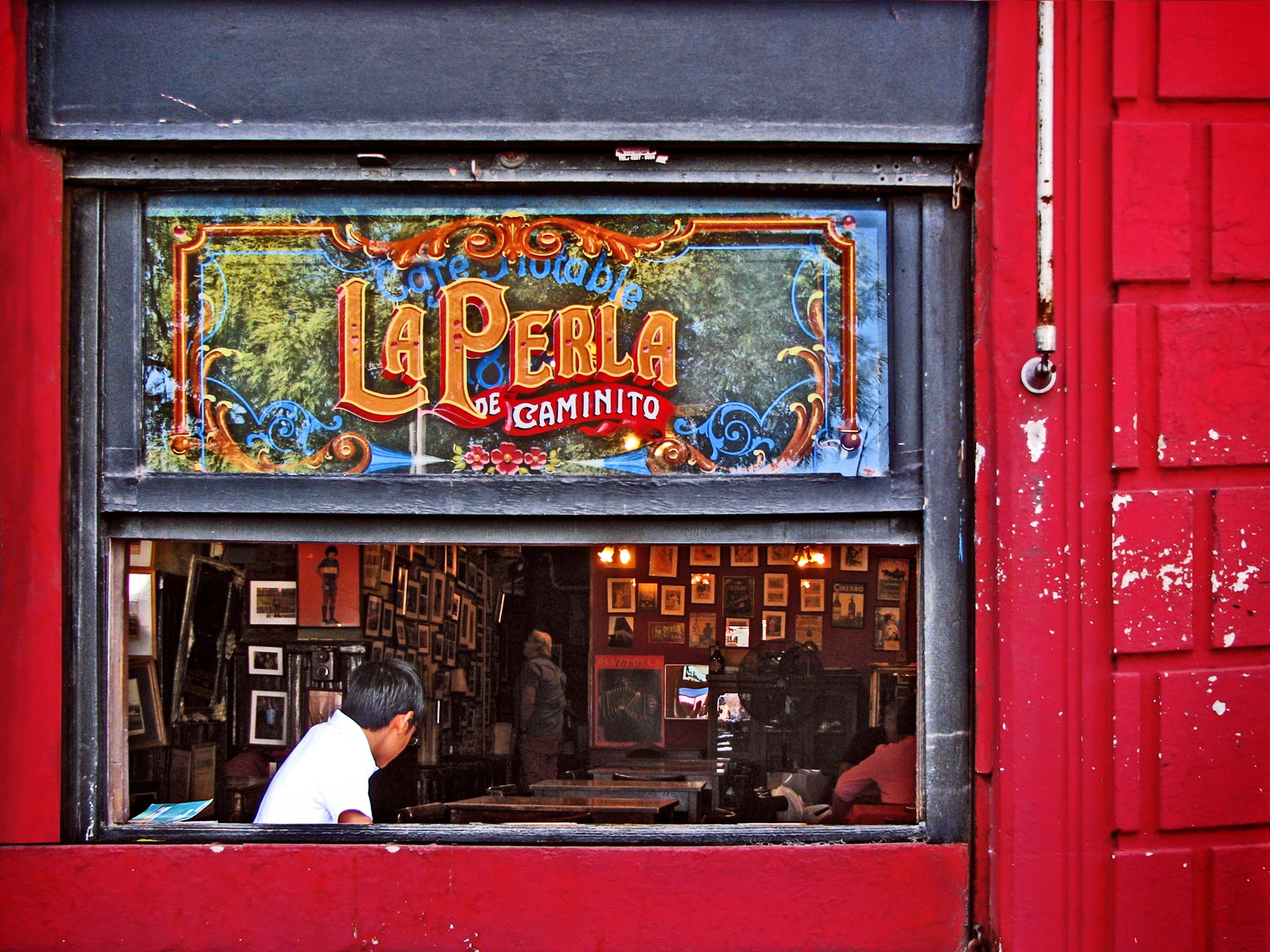 the interior of a building with artworks on its walls seen through a window, la perla de caminito 4k, HD Wallpaper