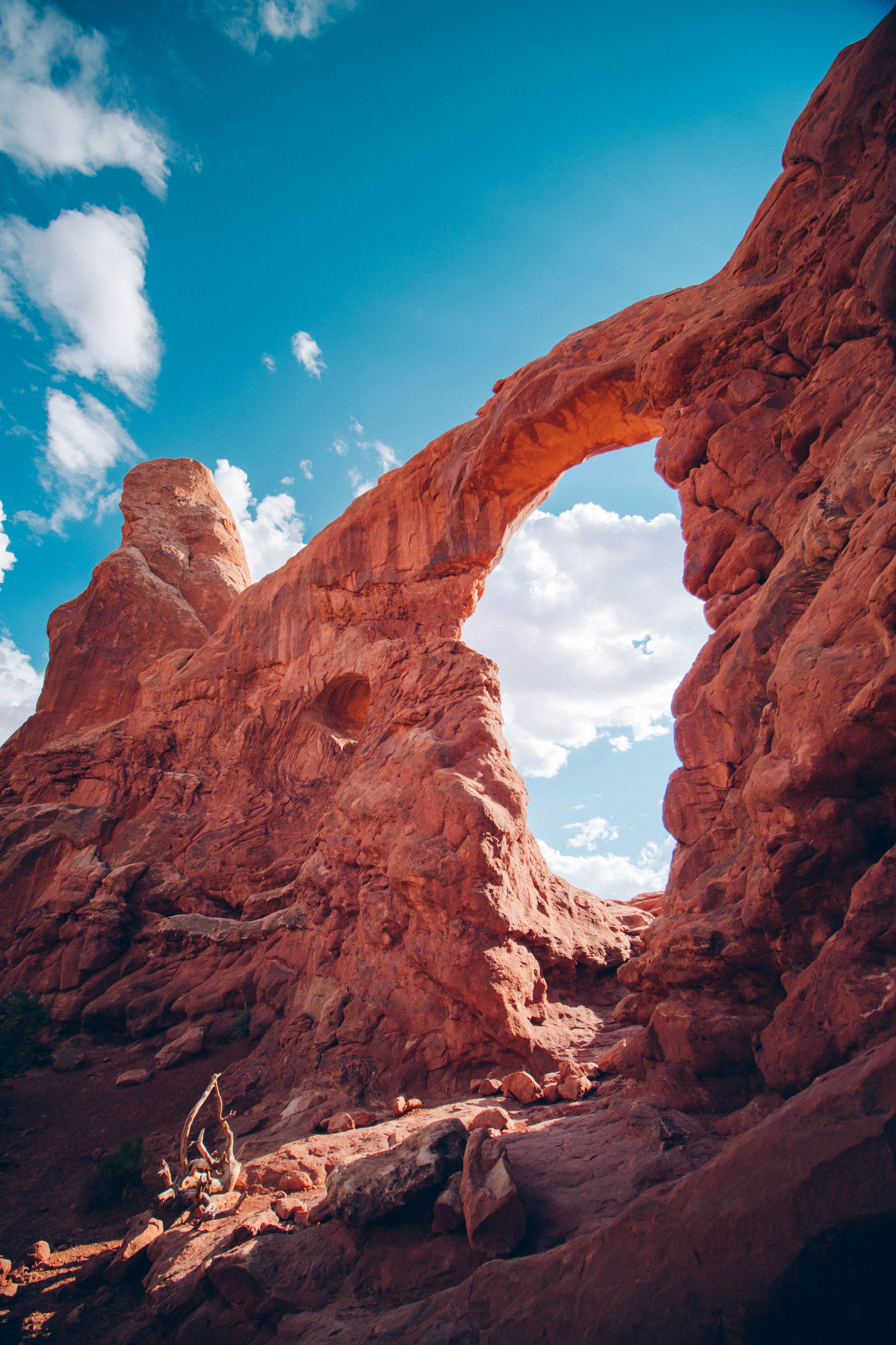 unique orange rock formation forms an archway against a blue sky, sandstone and sky 4k, Phone HD Wallpaper