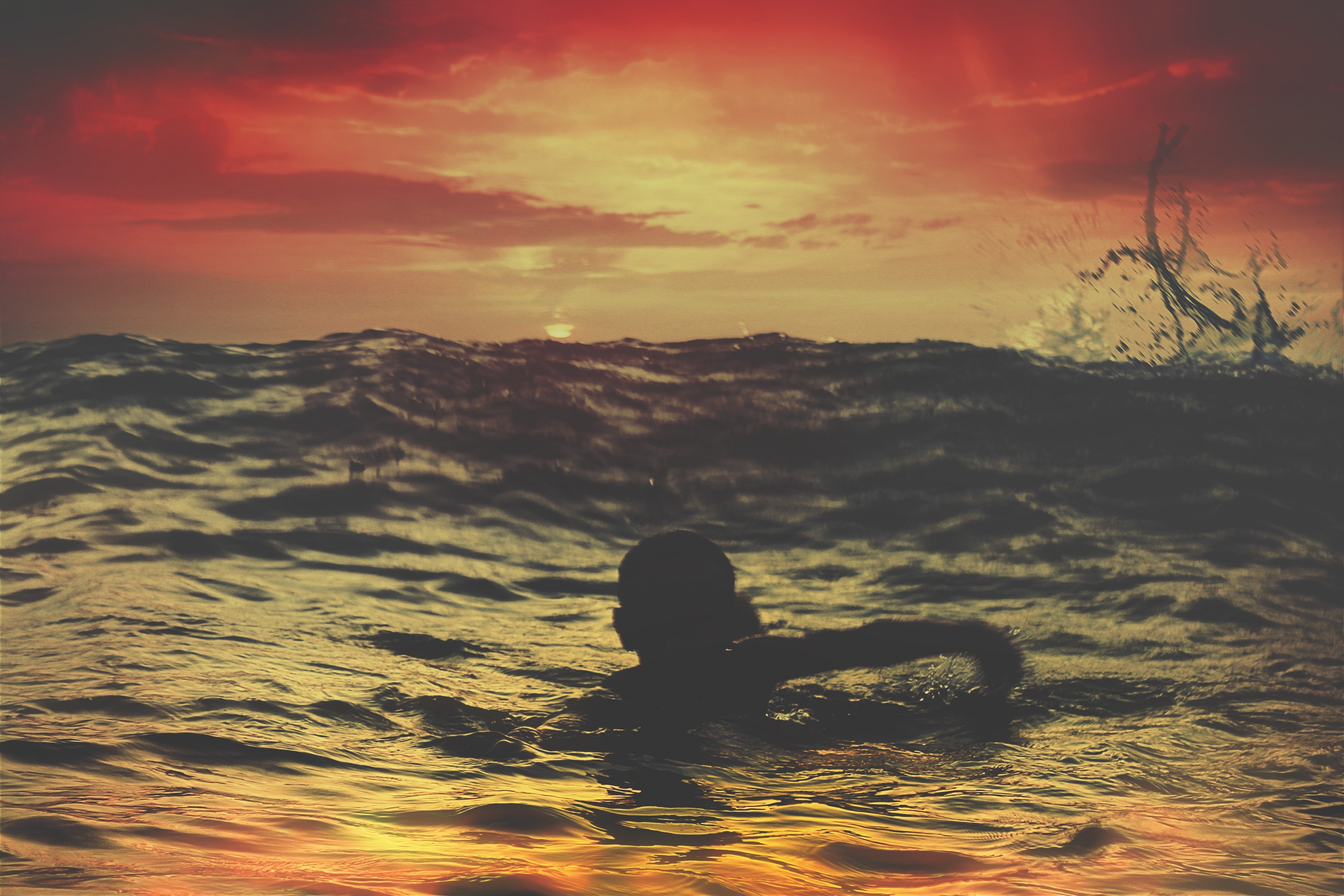 a person swimming in the rough waters of asilah beach morocco as the sun sets, person swimming in asilah 4k, HD Wallpaper