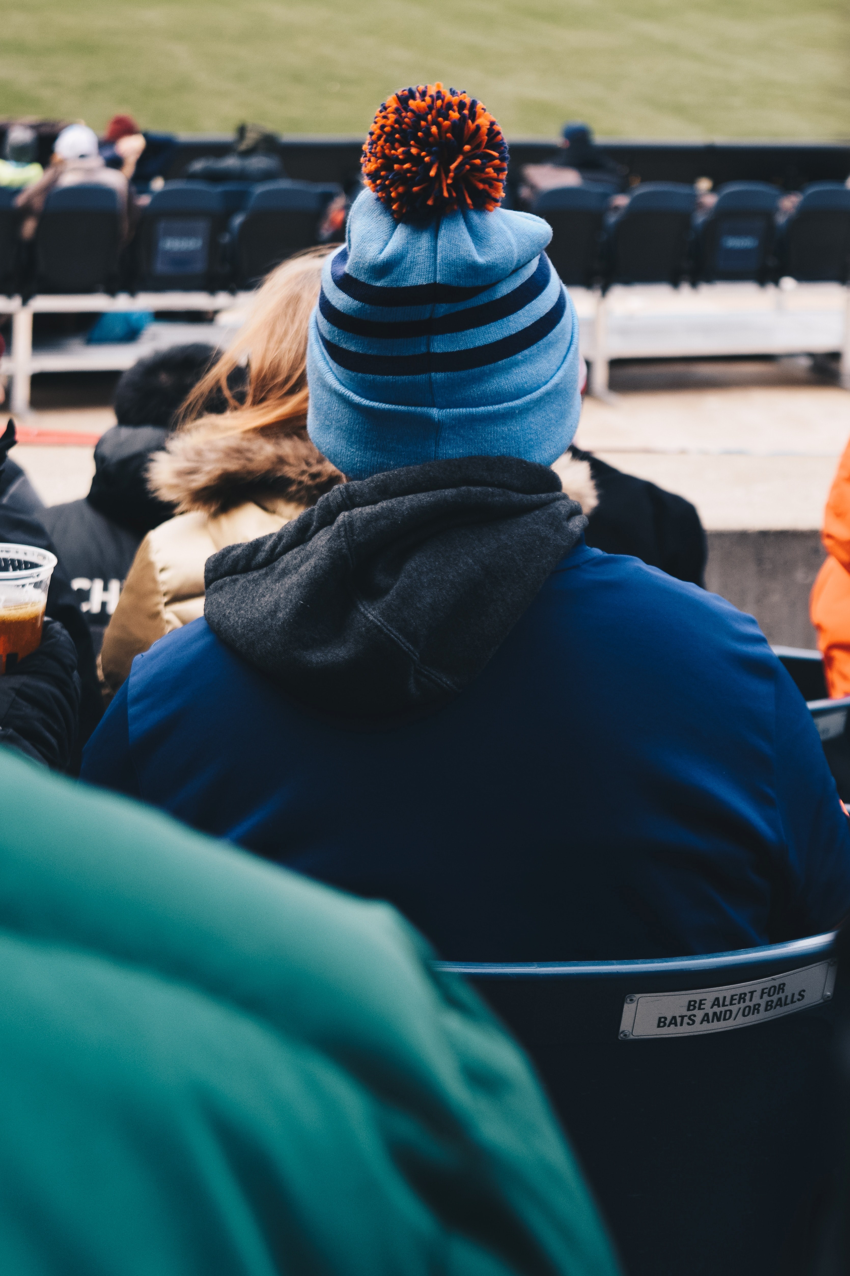 a man wearing a blue hat with a pom pom on it watches a baseball game at yankee stadium in new york city, spectator in bobble hat at the yankee stadium 4k, Phone HD Wallpaper