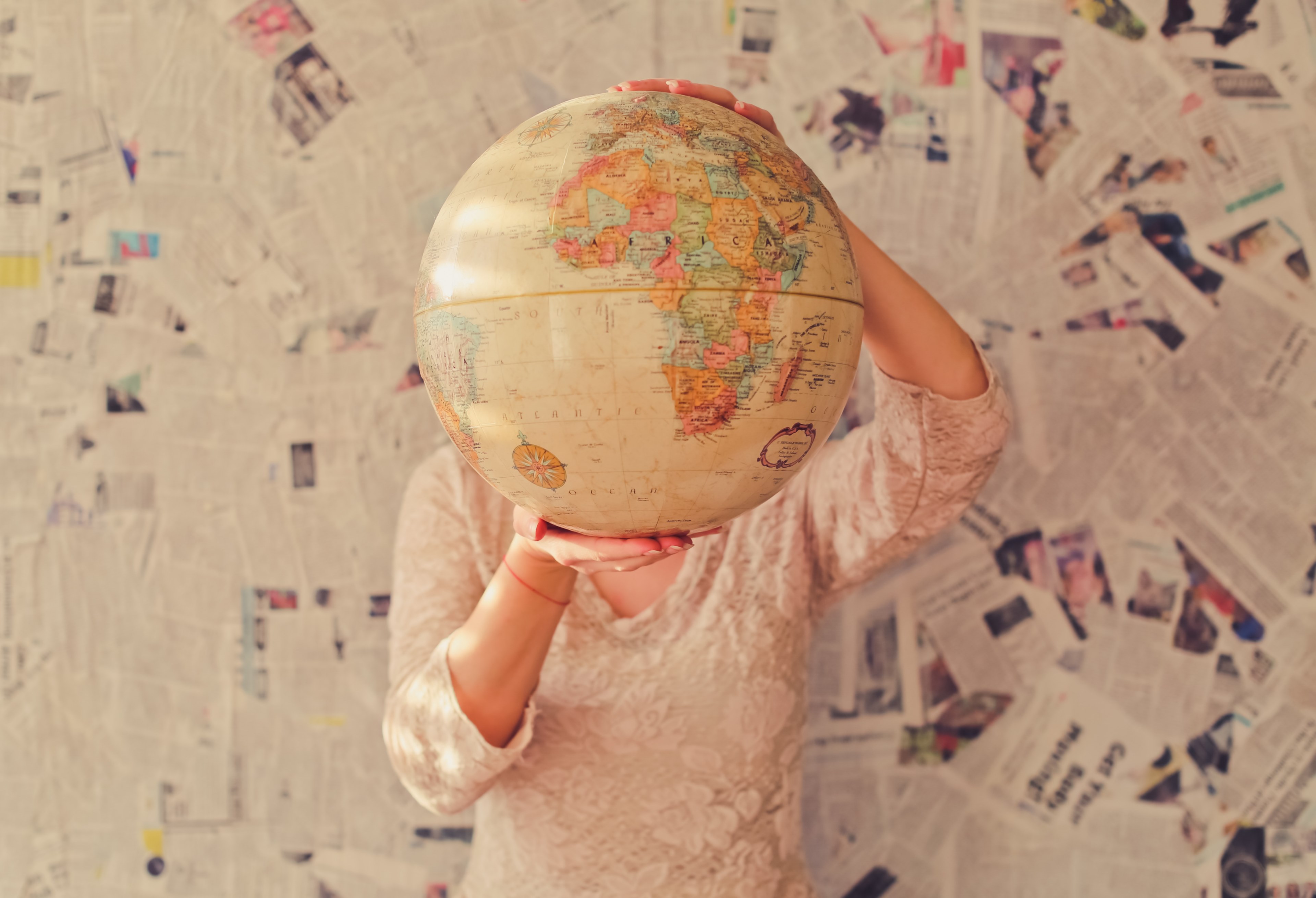 a woman in a lace blouse holding up a globe in front of her head, globe head 4k, HD Wallpaper