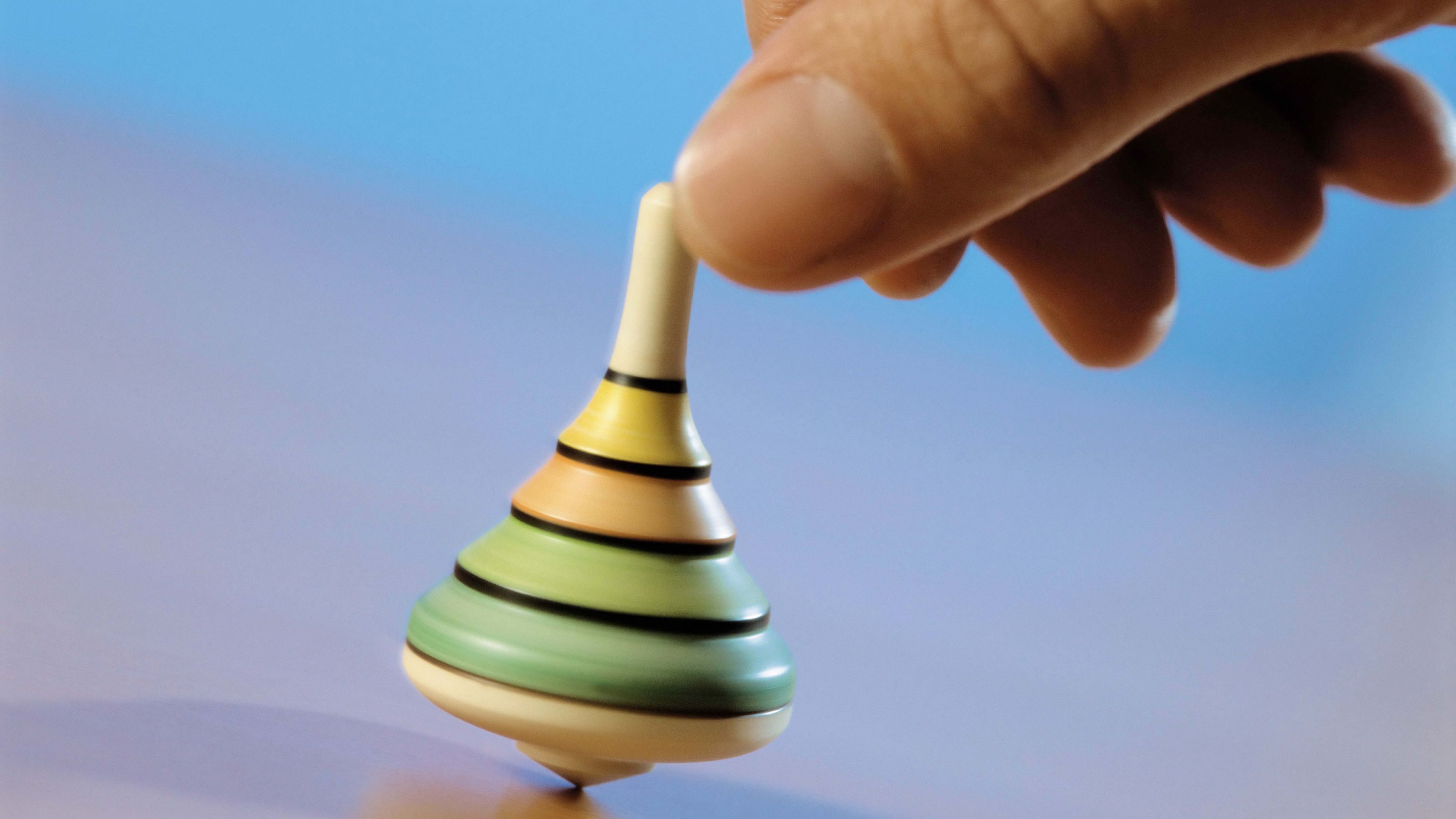 hand, spinning top, toy, blue background, 4k, HD Wallpaper