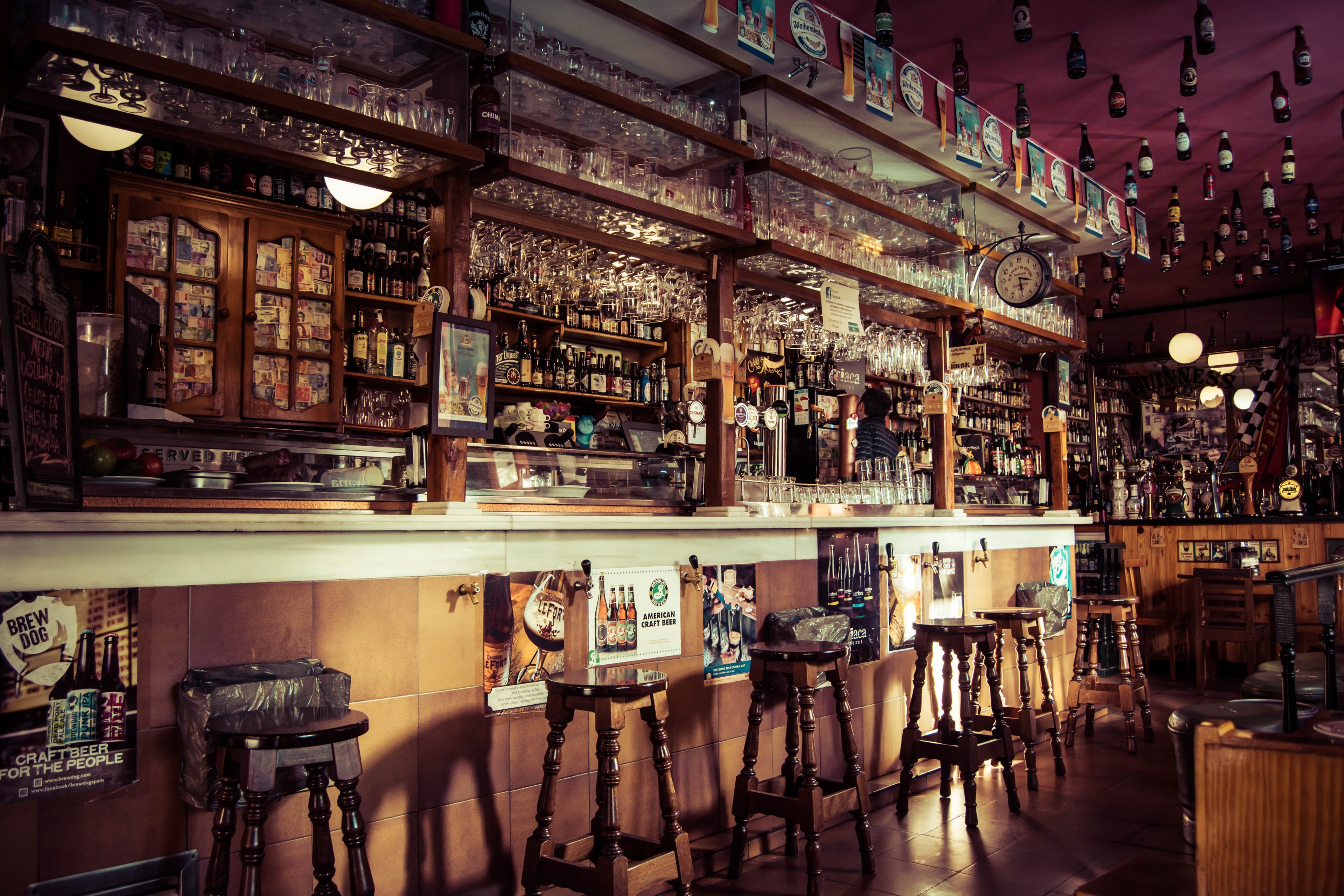 the interior of a bar with stools glass cups and empty bottles attached to the roof in madrid, cerveceria la mayor 4k, HD Wallpaper
