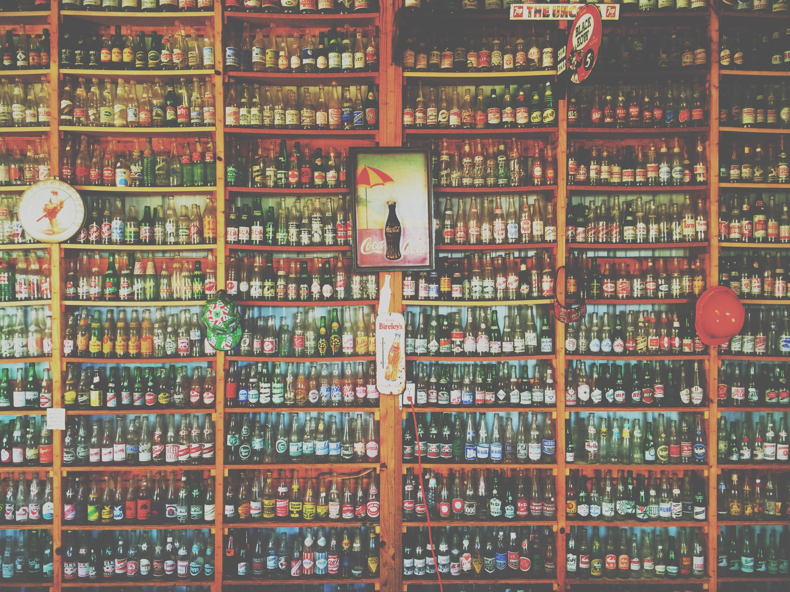a collection of vintage coca cola bottles on a large shelf, _coca cola bottles on a shelf 4k, HD Wallpaper