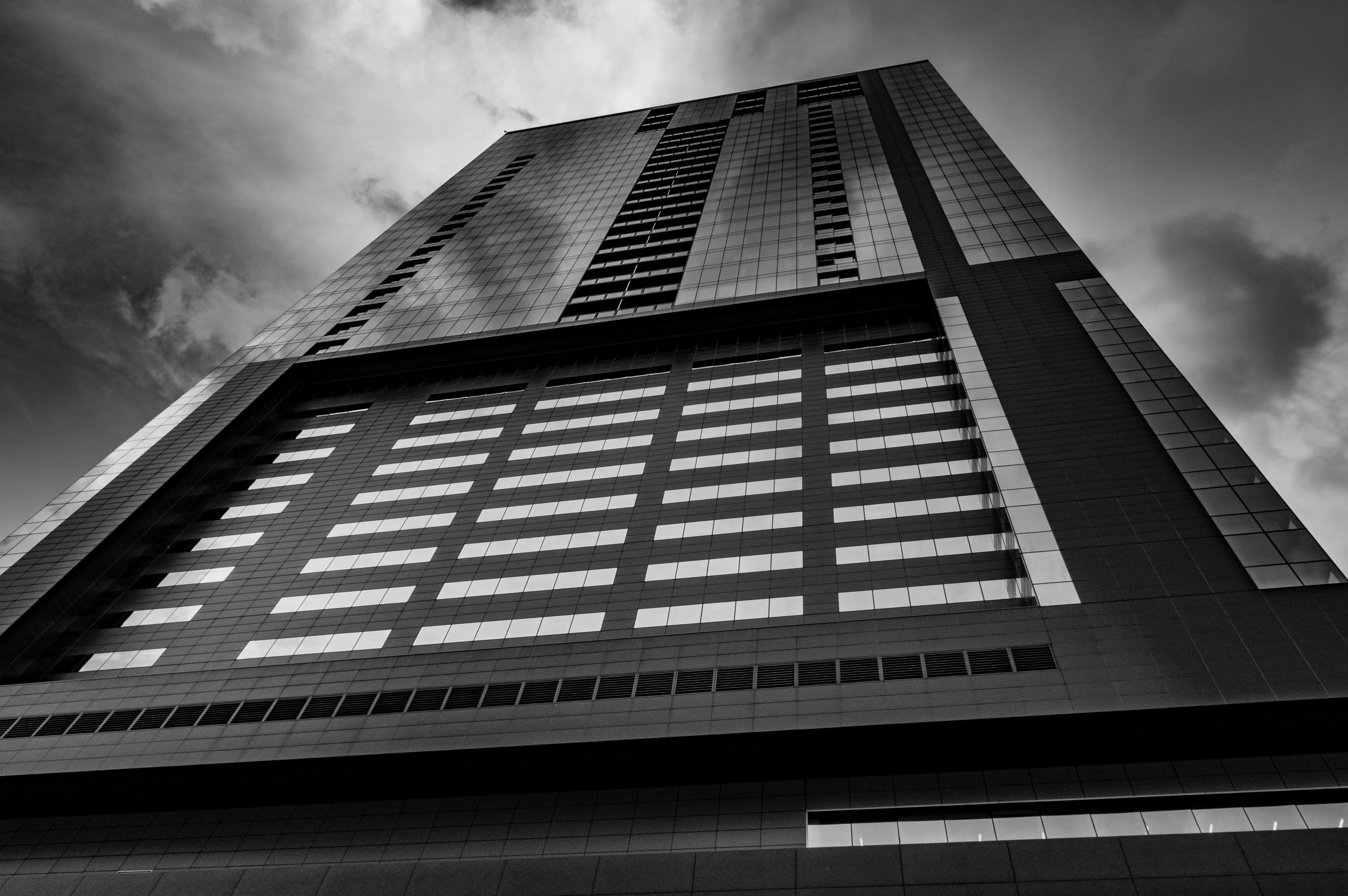 black and white shot of tower building architecture from below with cloudy sky in austin, tower in austin with clouds 4k, HD Wallpaper