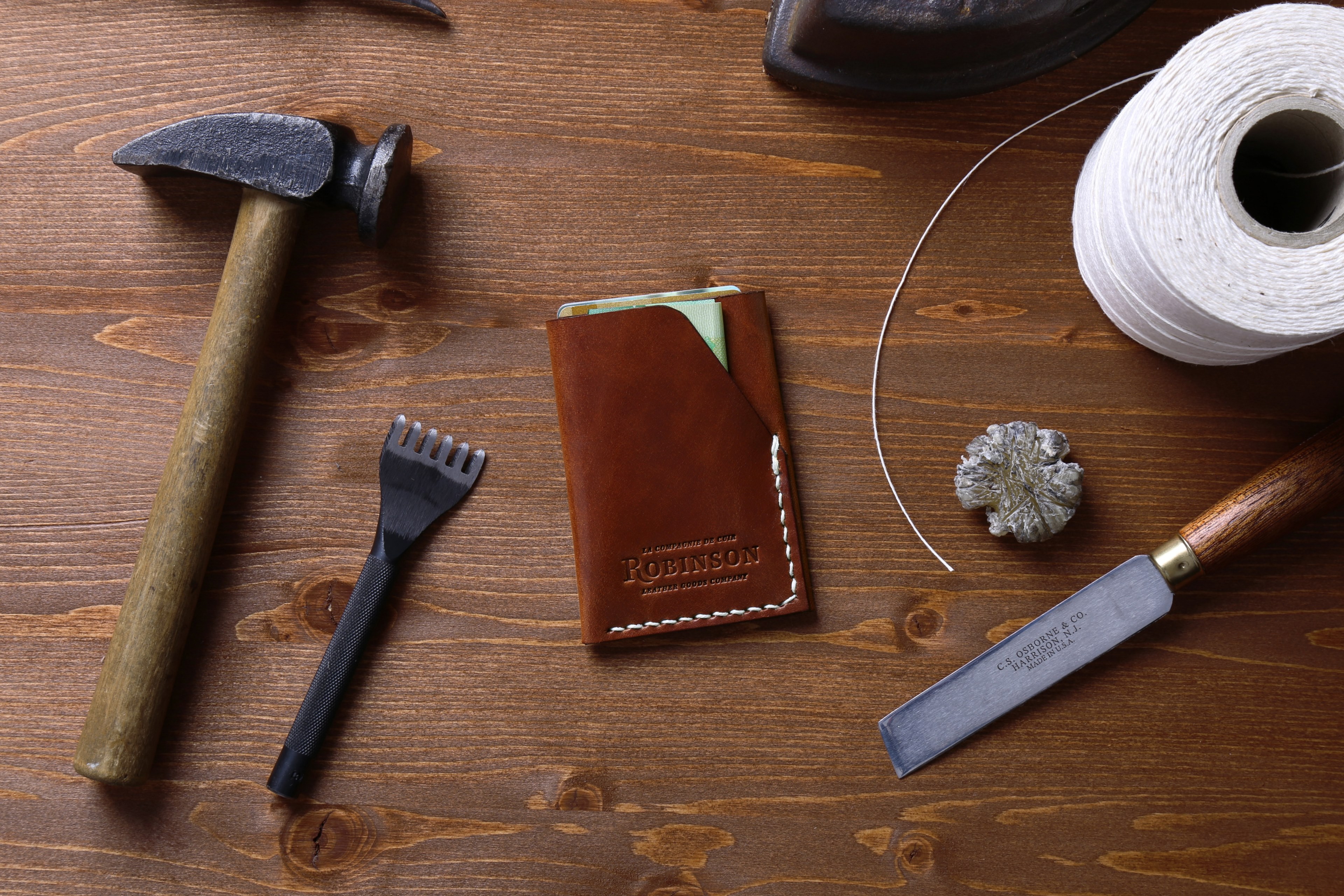 an overhead shot of a leather document sleeve among various tools on a wooden surface, slim wallet handcrafted 4k, HD Wallpaper