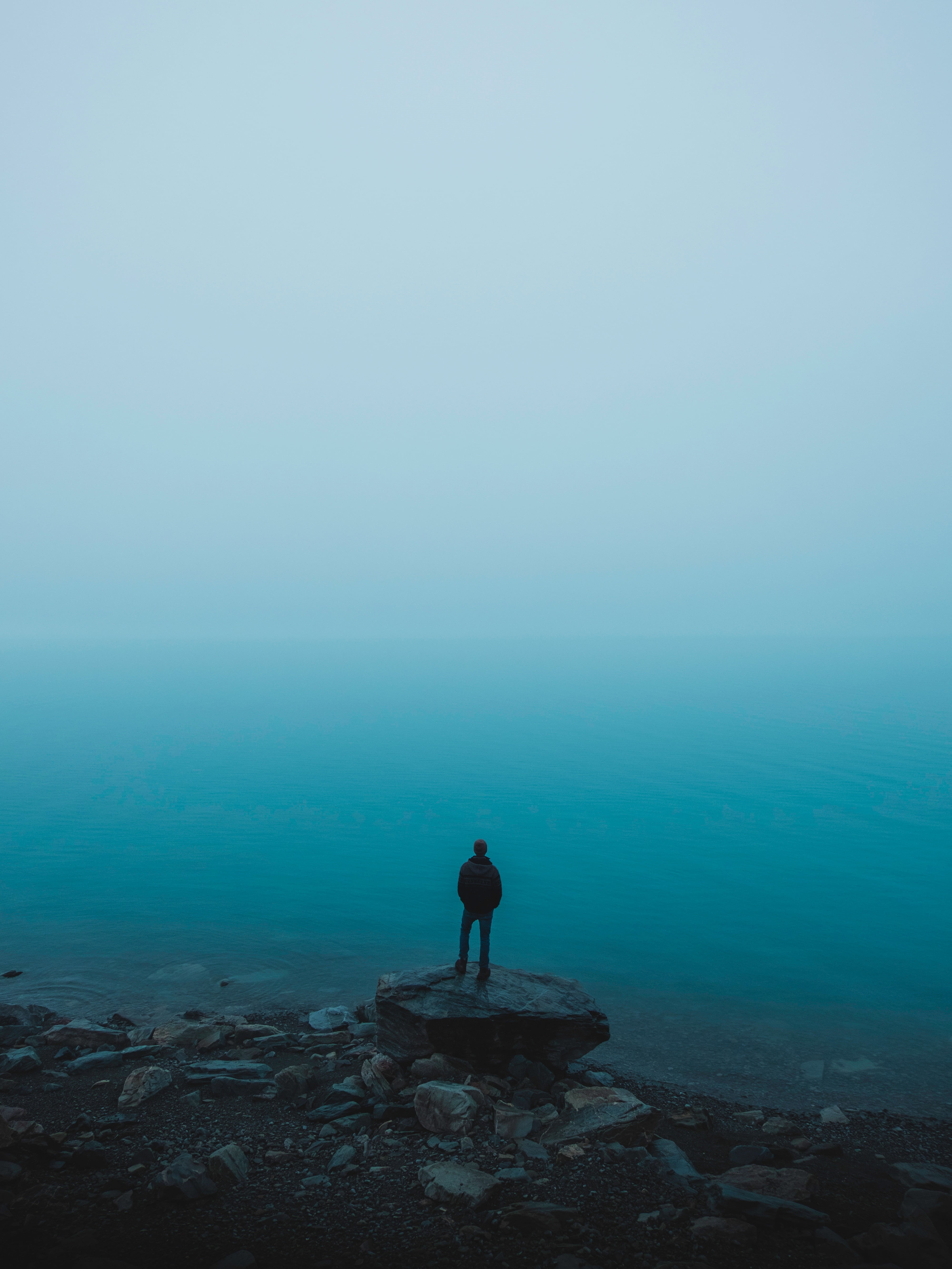 beauty in nature, hiking, nature, backpack, man, blue, loneliness, stones, cliff, sky, sunset, solid, water, women, scenics - nature, alone, landscape, Phone HD Wallpaper