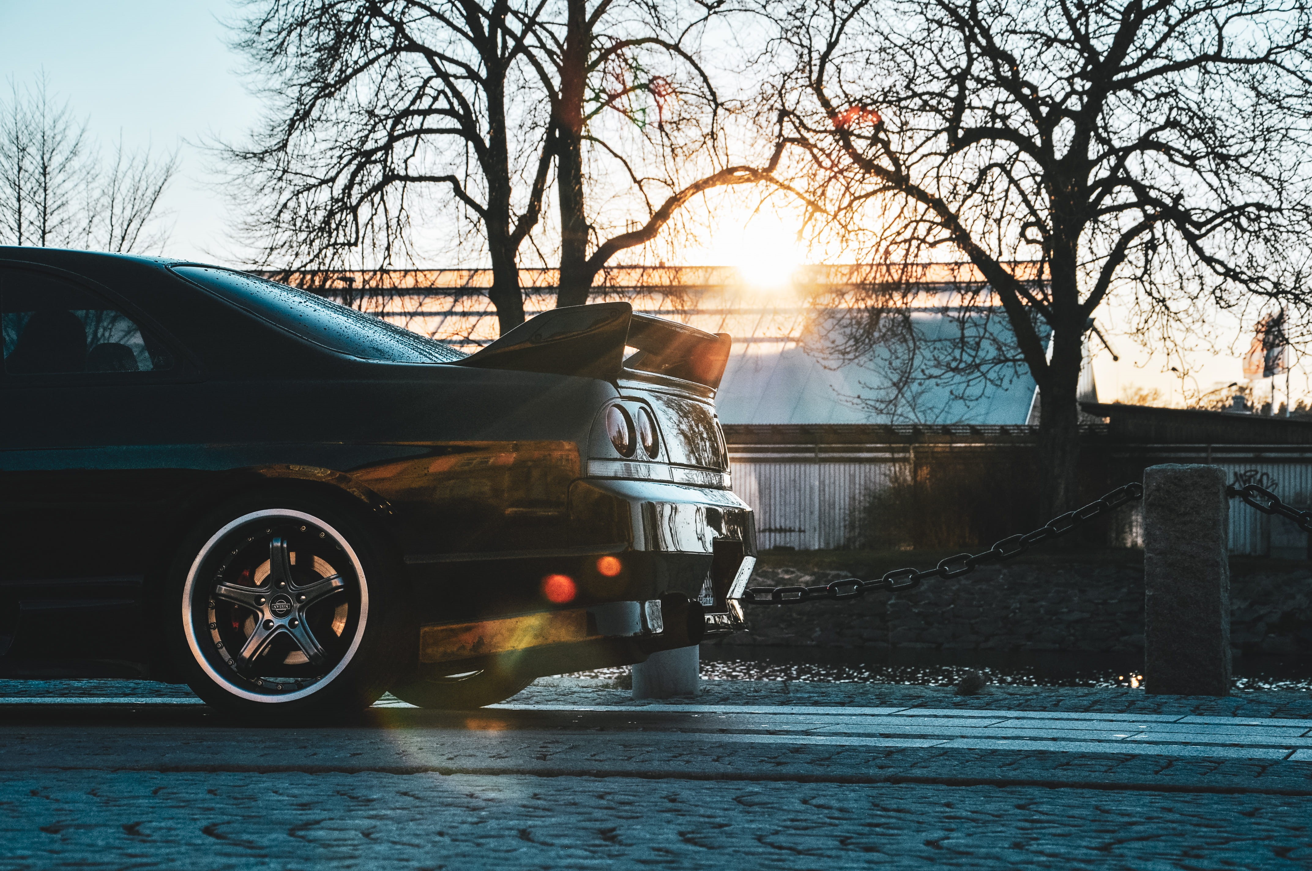 jdm, black, 4K, vänersborg, plant, wheel, transportation, land vehicle, no people, automobile, car, alloy wheel, architecture, sky, nissan, sunlight, outdoors, HD Wallpaper
