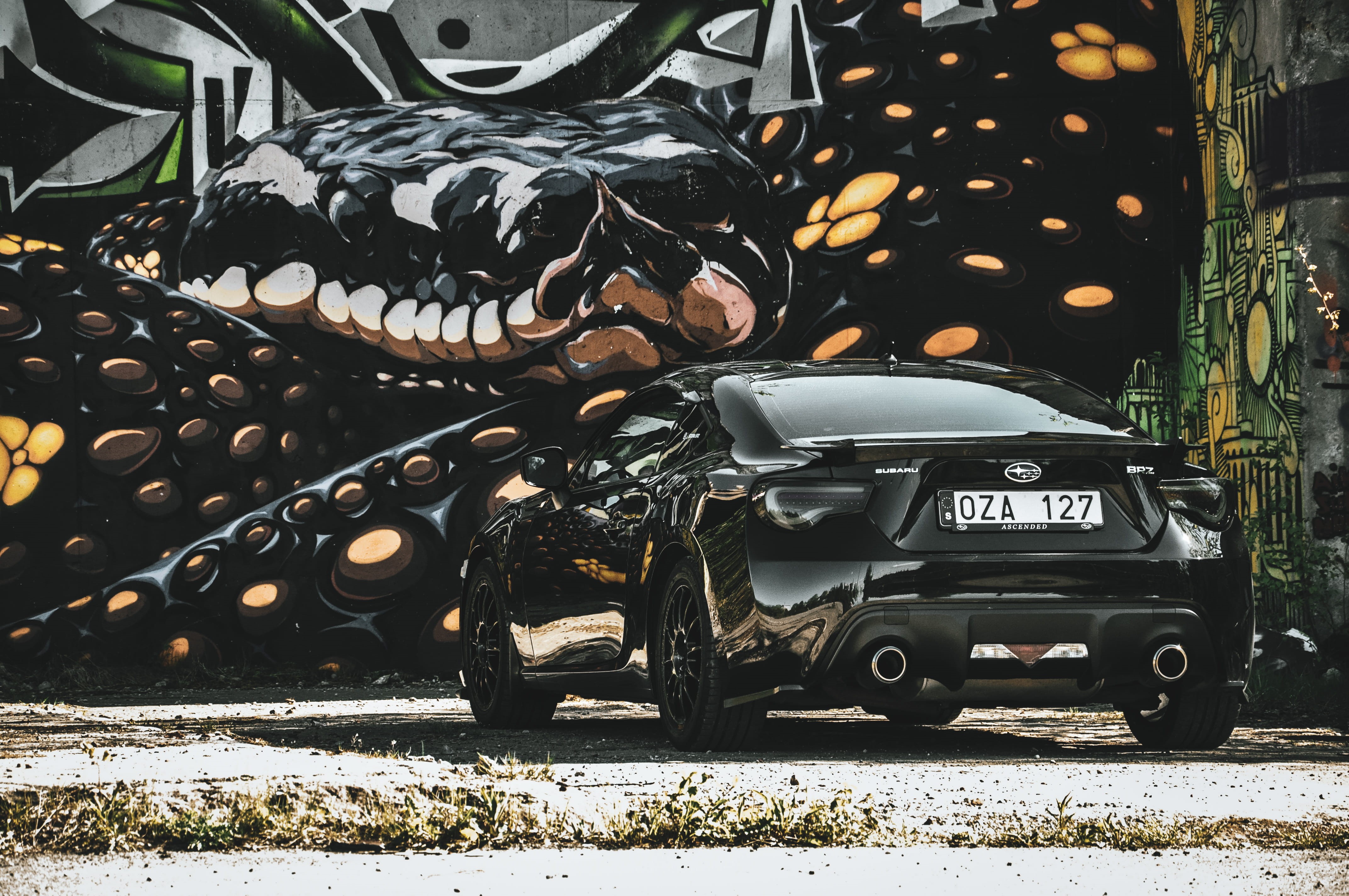 nature, cars, stationary, city, sweden, 4K, graffiti, no people, art, black color, outdoors, vehicle, spoke, mode of transportation, text, sports car, HD Wallpaper