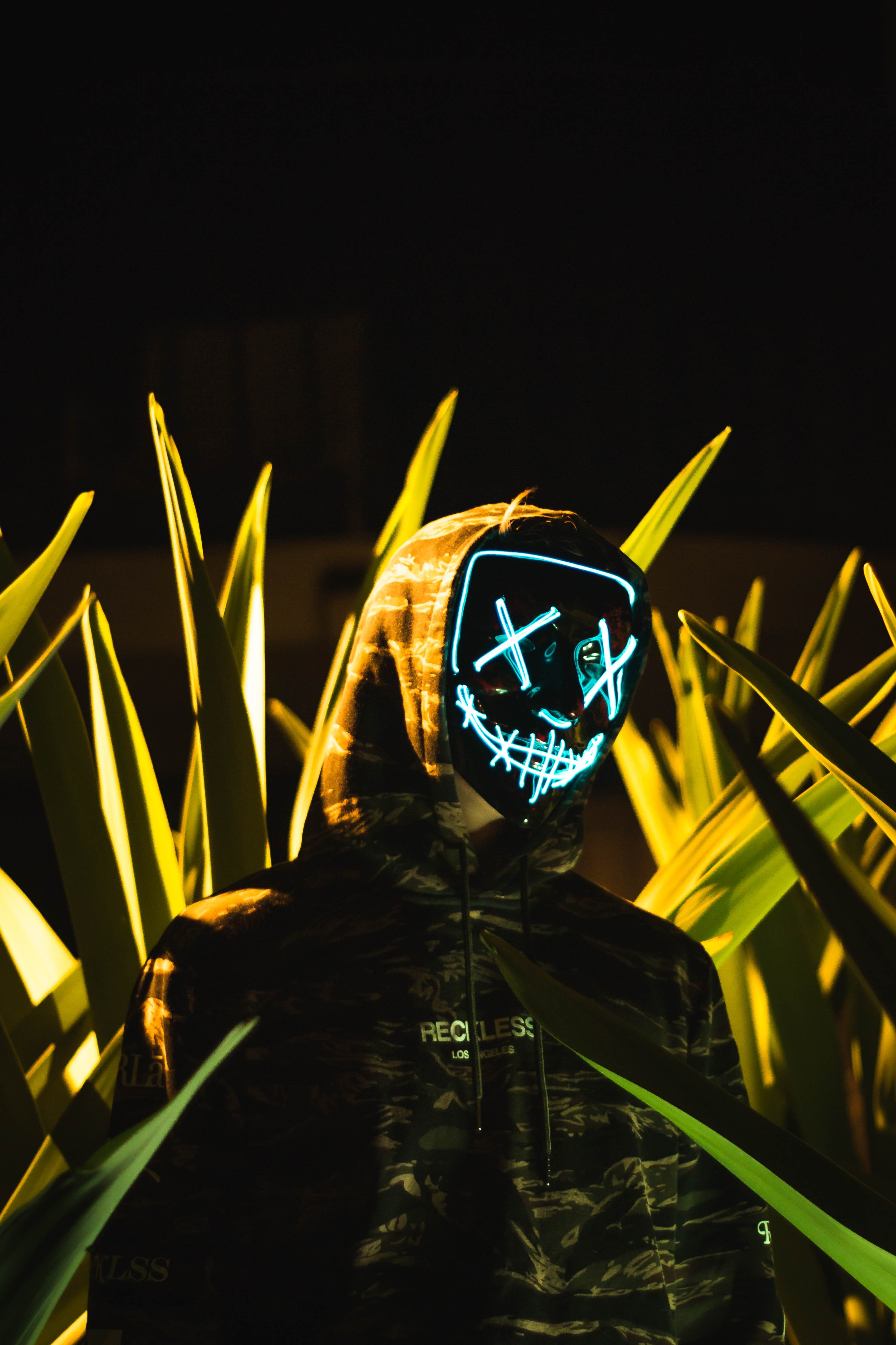 halloween, symbol, mask, scary, no People, person, light - Natural Phenomenon, grass, illuminated, pose, smile, seriou, neon, plant, hoodie, black Color, Phone HD Wallpaper
