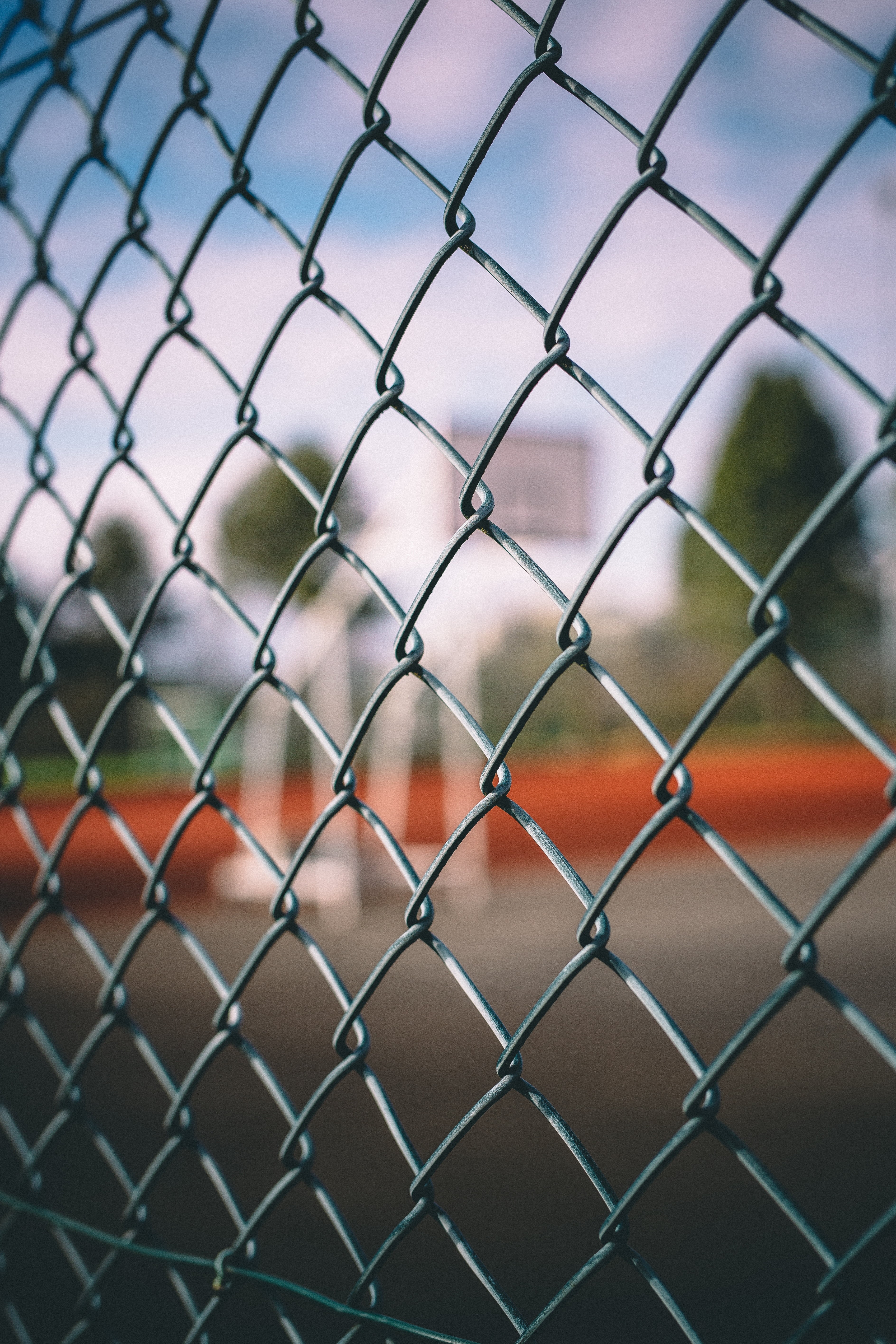 focus on foreground, tennis, backgrounds, close-up, day, protection, playing field, selective focus, fence, cyclone, nature, no People, barrier, steel, Phone HD Wallpaper