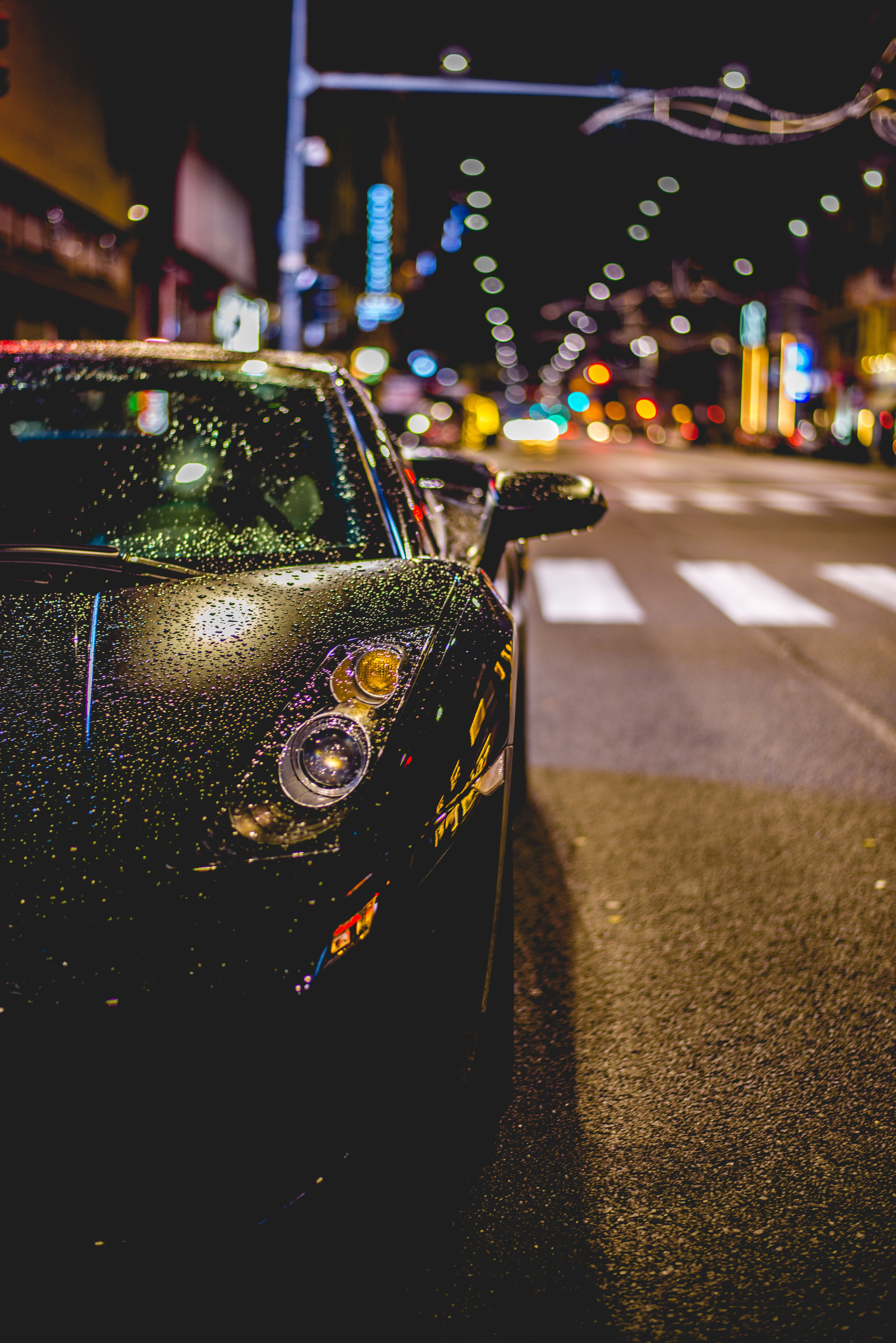 rain, outdoors, street, wheeled vehicle, focus on foreground, illuminated, water, night, building exterior, transportation, road, bokeh, land Vehicle, drops, Phone HD Wallpaper
