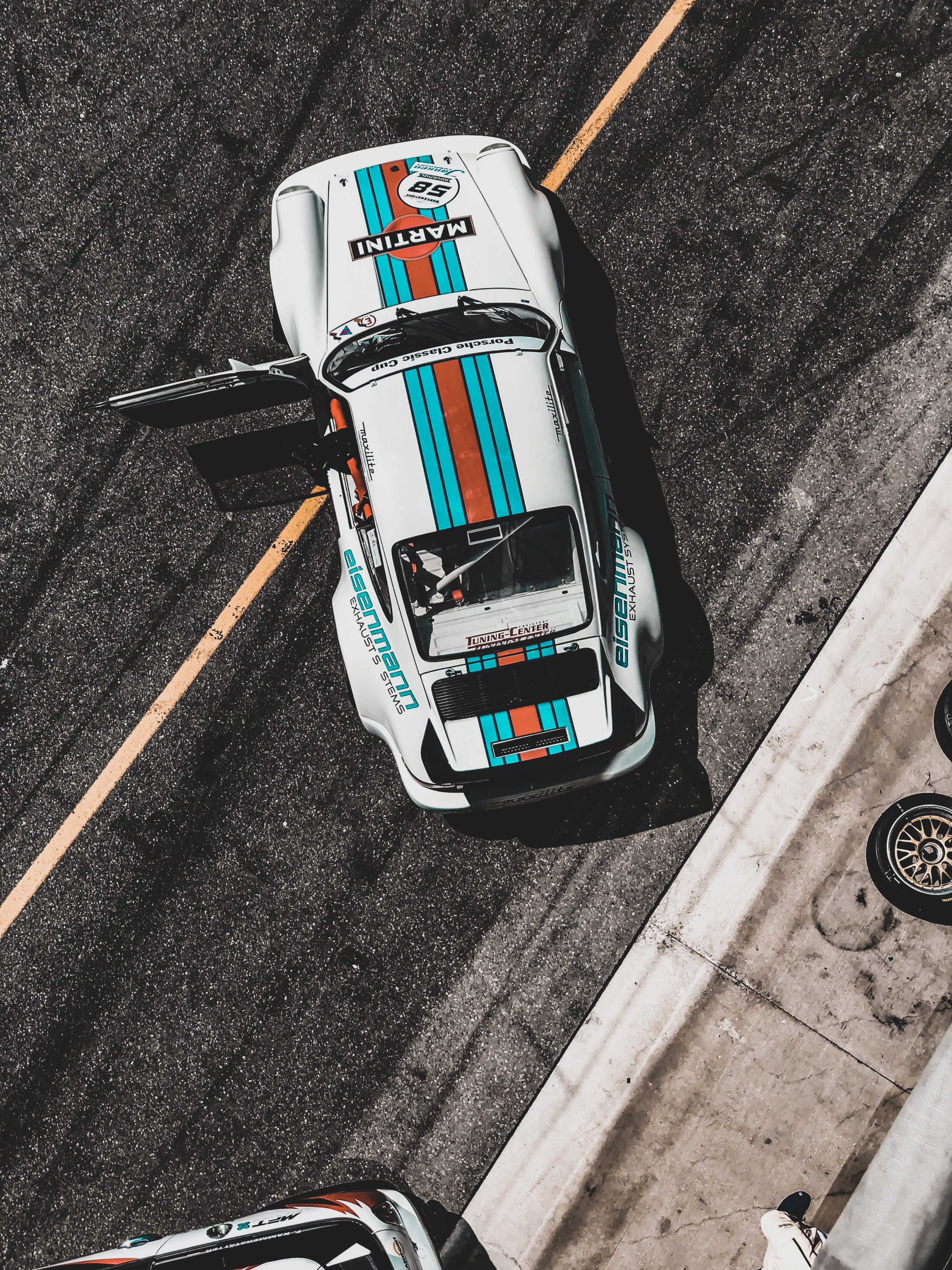 cars, automobile, travel, sign, sports, road, supercars, communication, martini racing, high angle view, porsche 911, city, daytime, mode of transportation, Phone HD Wallpaper