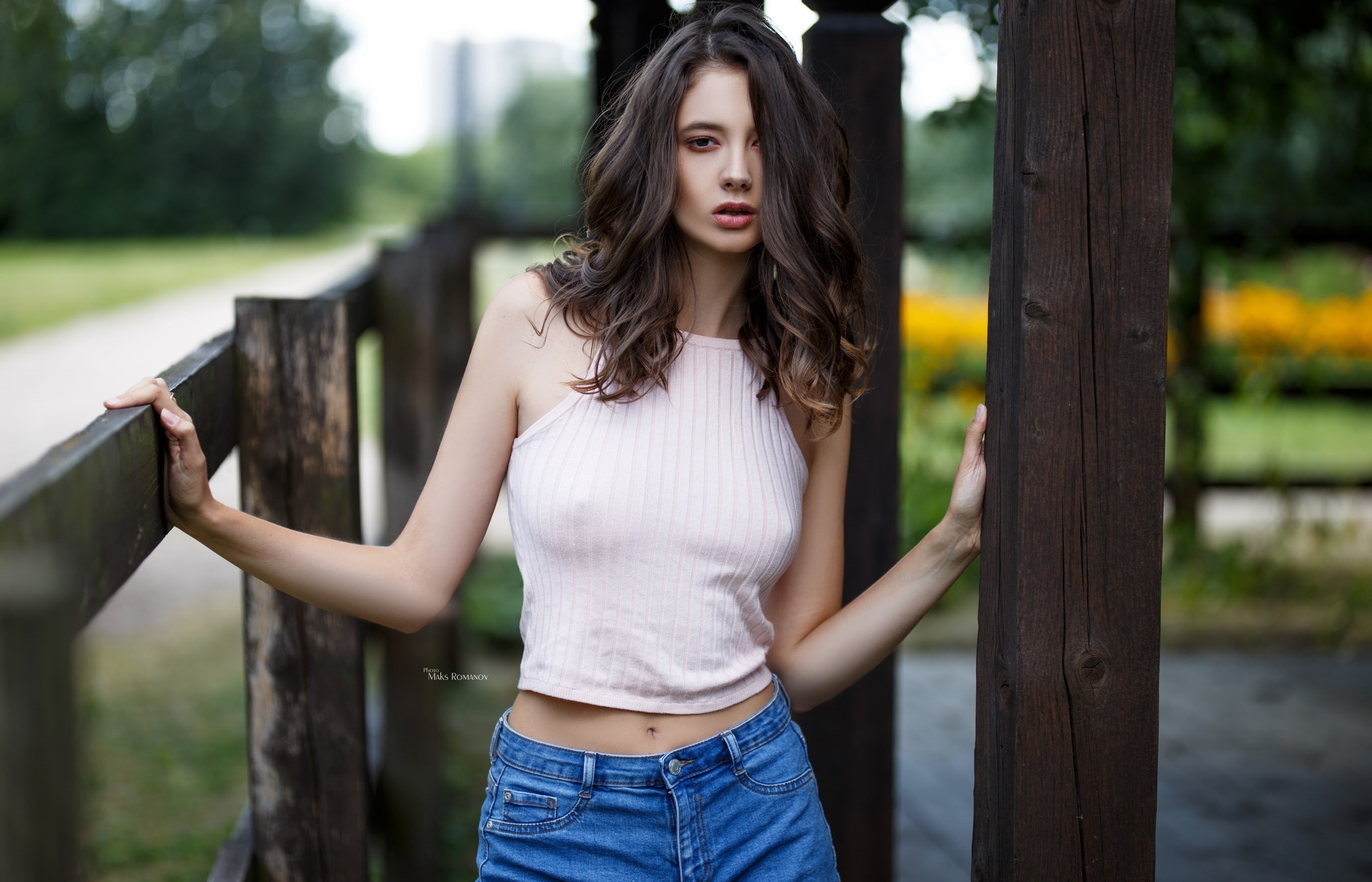 looking at viewer, fence, model, women outdoors, crop top, portrait, hair in face, wood, depth of field, jeans, Maksim Romanov, belly, brunette, 2K, open mouth, HD Wallpaper