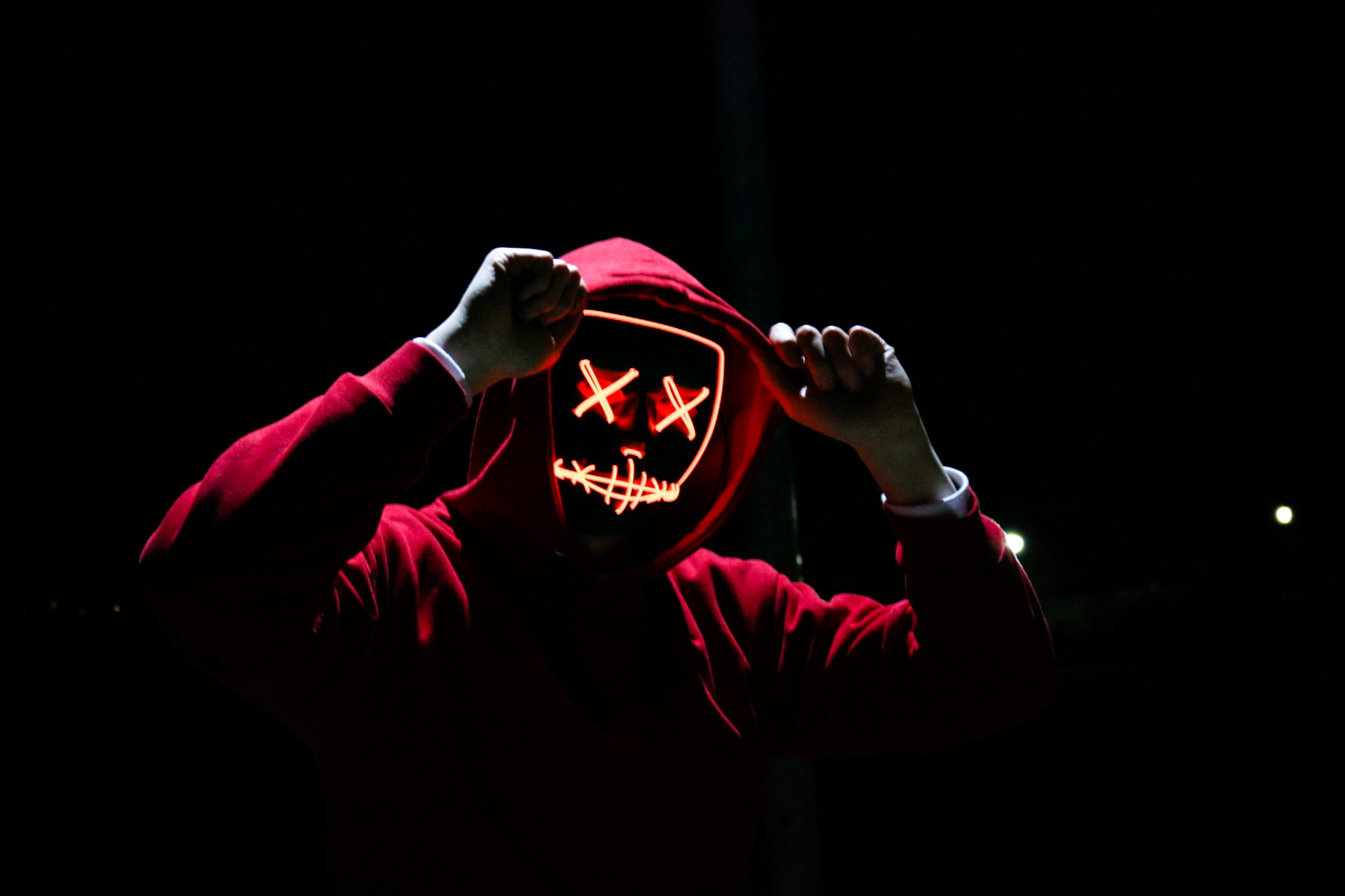 hoody sweater, dark, studio shot, lifestyles, portrait, red, mask, real people, spooky, person, young adult, celebration, hood, one person, lights, illuminated, HD Wallpaper