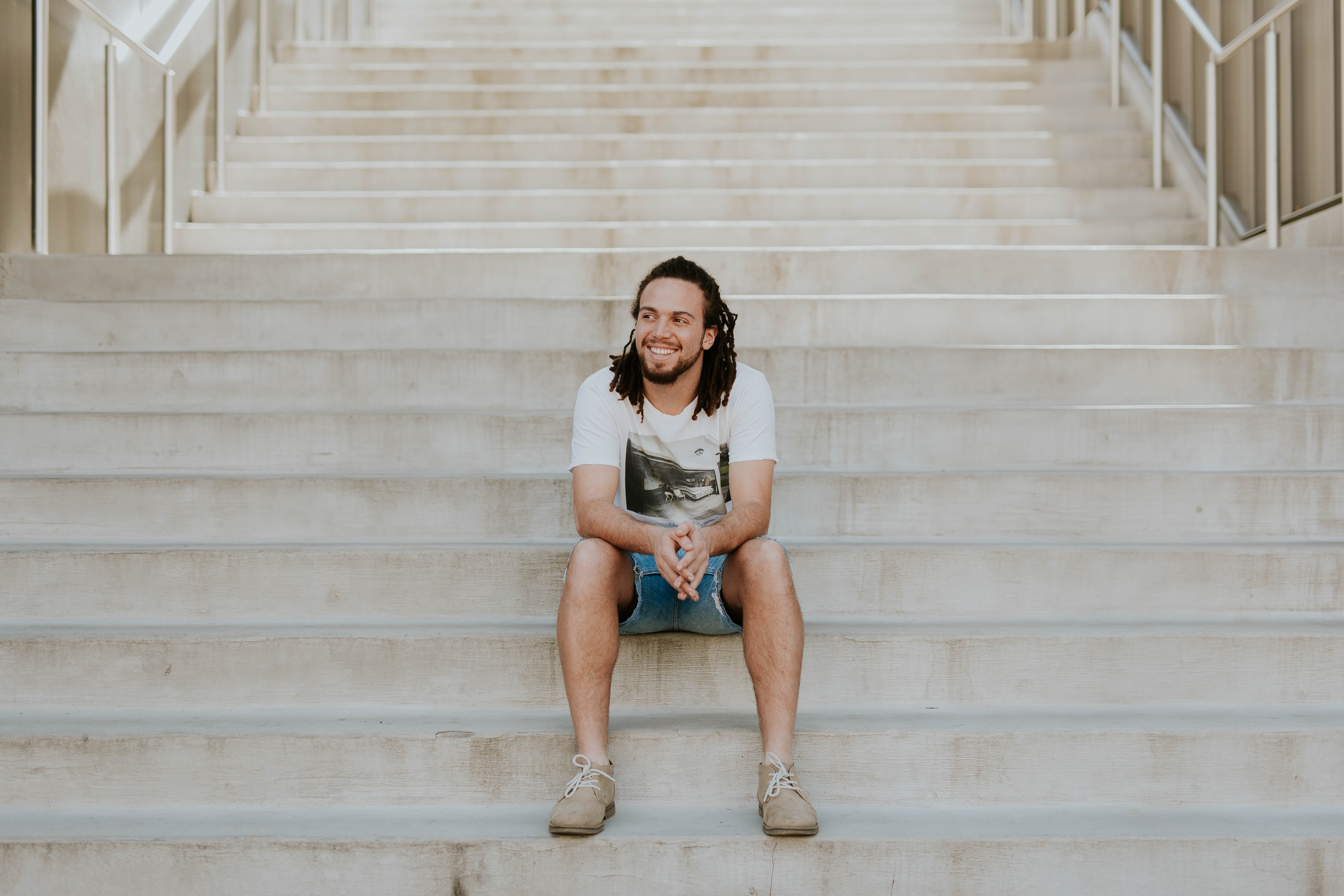 young adult, lifestyles, looking at camera, women, man, relaxation, stairs, emotion, architecture, adult, leisure activity, steps and staircases, shorts, HD Wallpaper