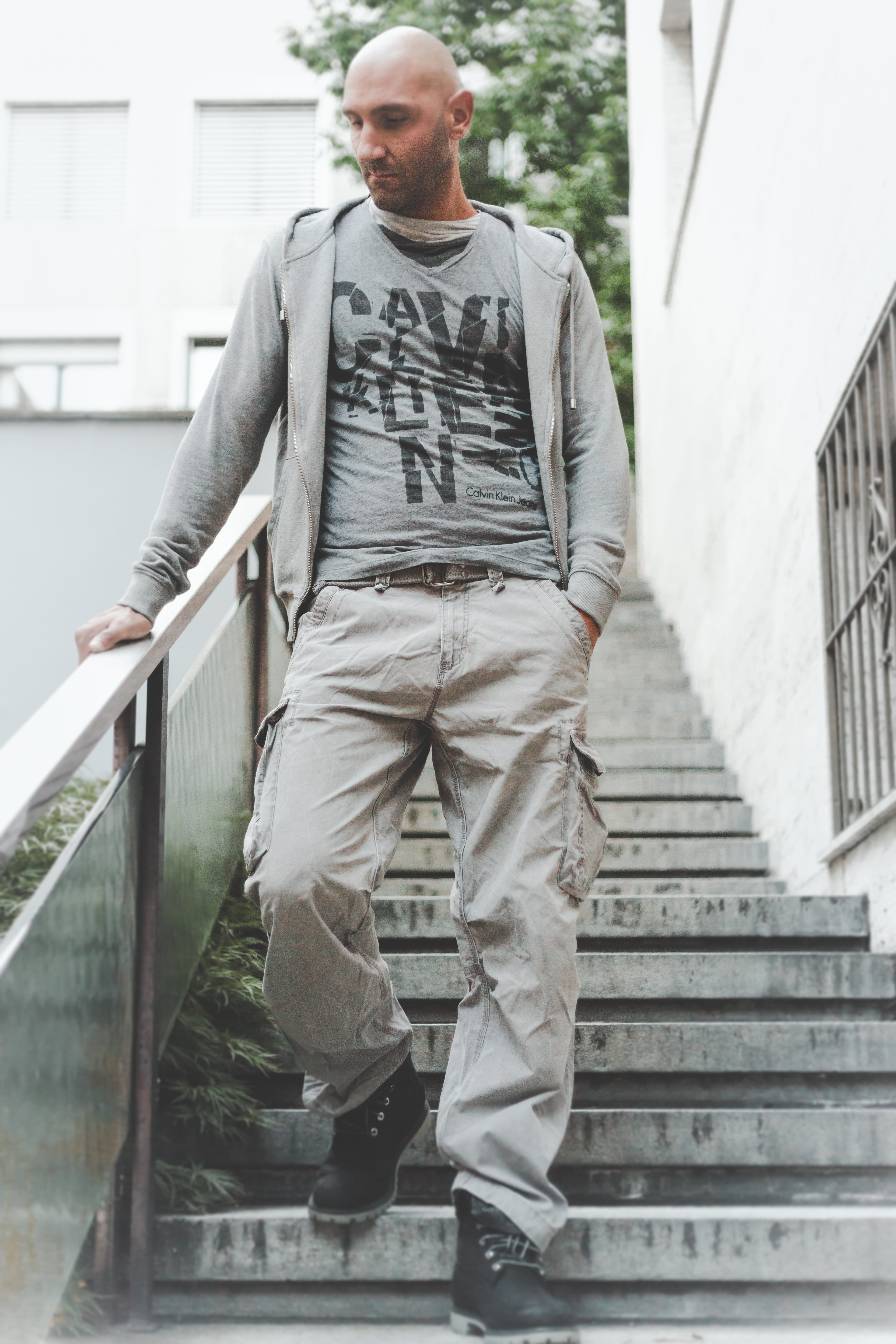 front view, guy, male, handrail, outdoors, adult, grey, wear, building, jacket, zip, model, boots, brown, lifestyles, young men, fashion, concrete, built structure, Phone HD Wallpaper
