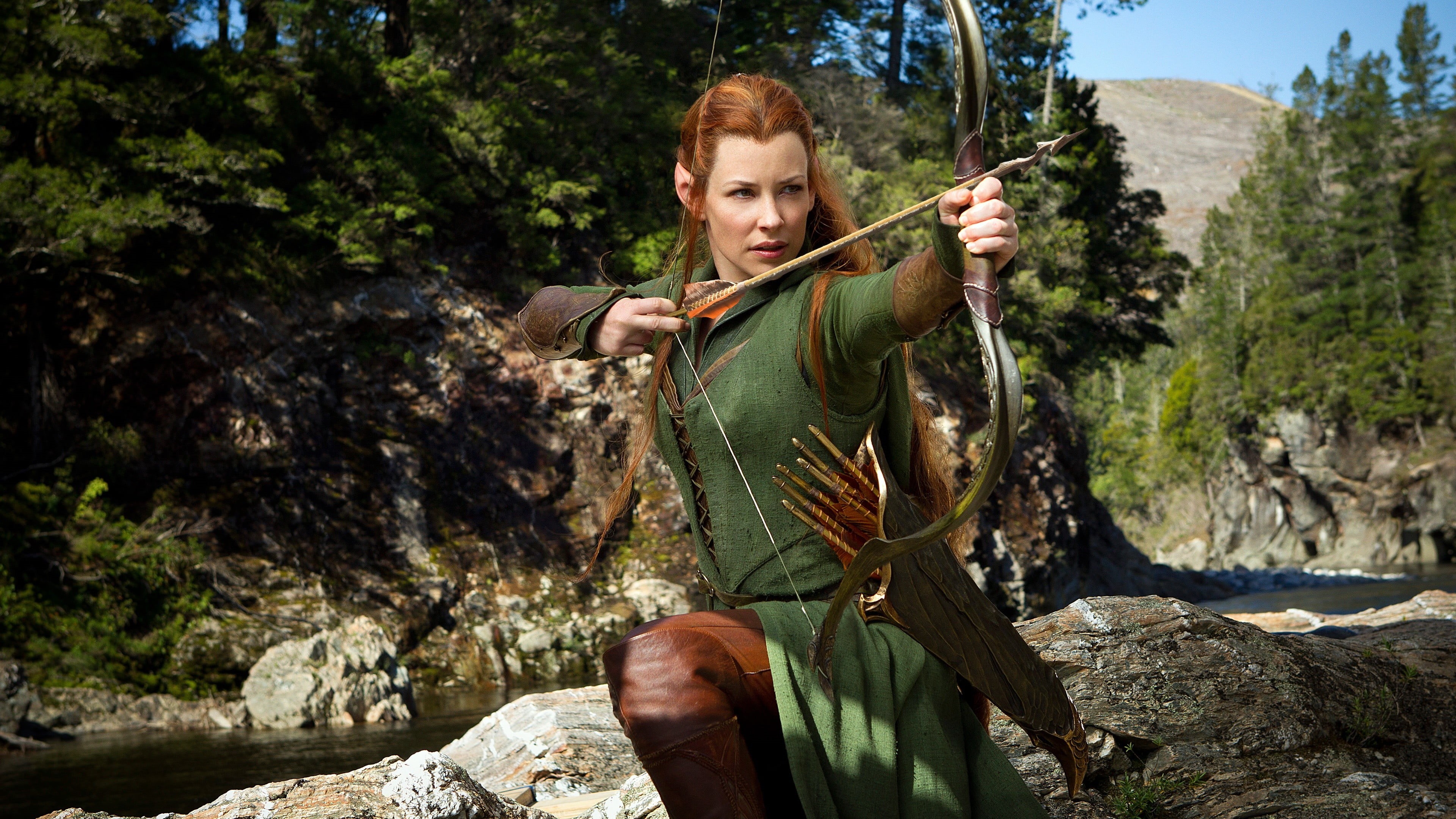 The Hobbit, outdoors, holding, sunlight, Tauriel, tree, leisure activity, redhead, front view, Evangeline Lilly, lifestyles, 4K, plant, portrait, rock - object, HD Wallpaper
