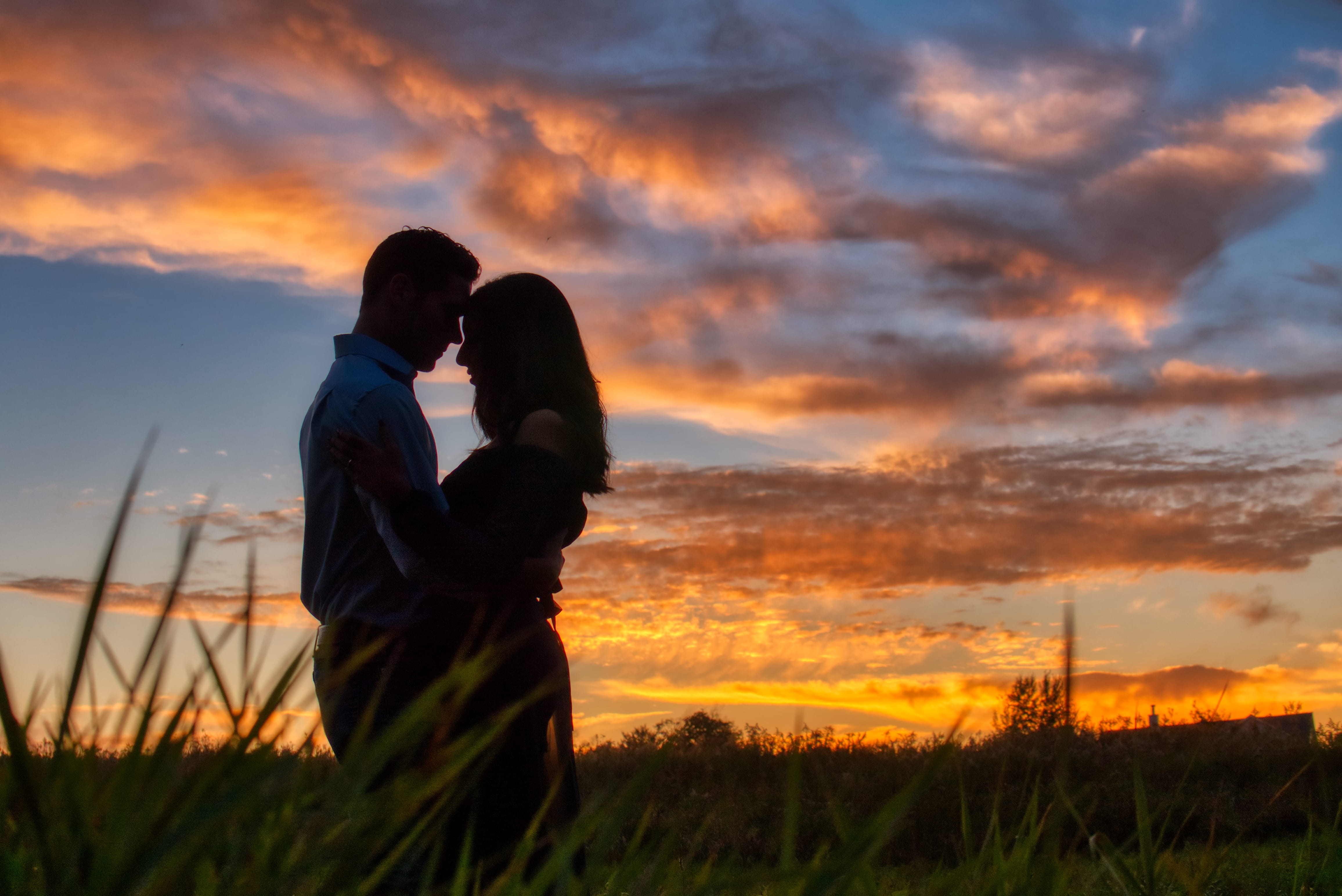 standing, romantic, men, hug, golden hour, grass, clouds, emotion, sky, field, sunrise, people, couple, dawn, orange color, cloud - sky, women, adult, nature, HD Wallpaper