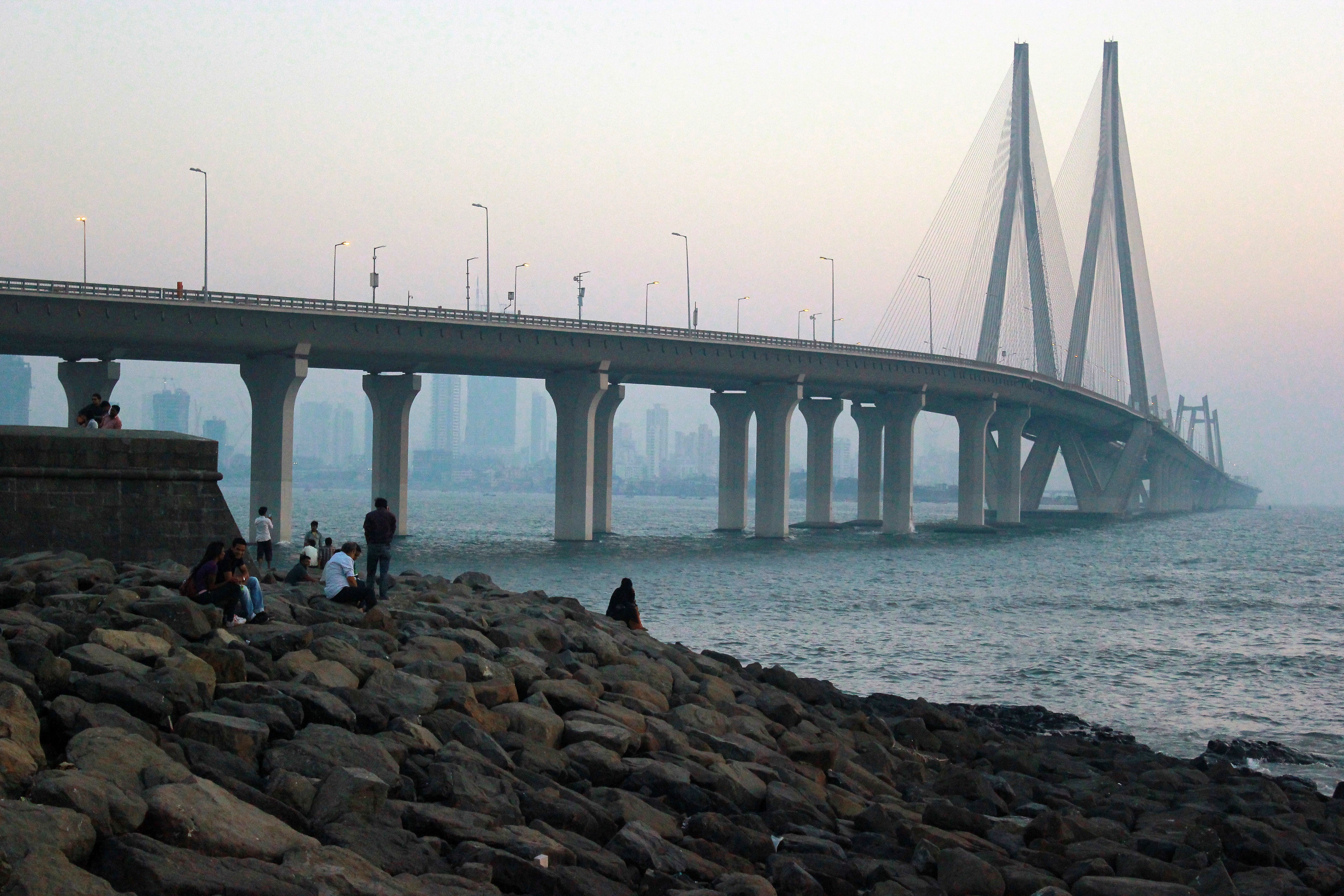 water, sea, 5K, rock - object, leisure activity, sky, outdoors, connection, structure, river, bandra, architecture, link, bridge, built structure, group of people, HD Wallpaper