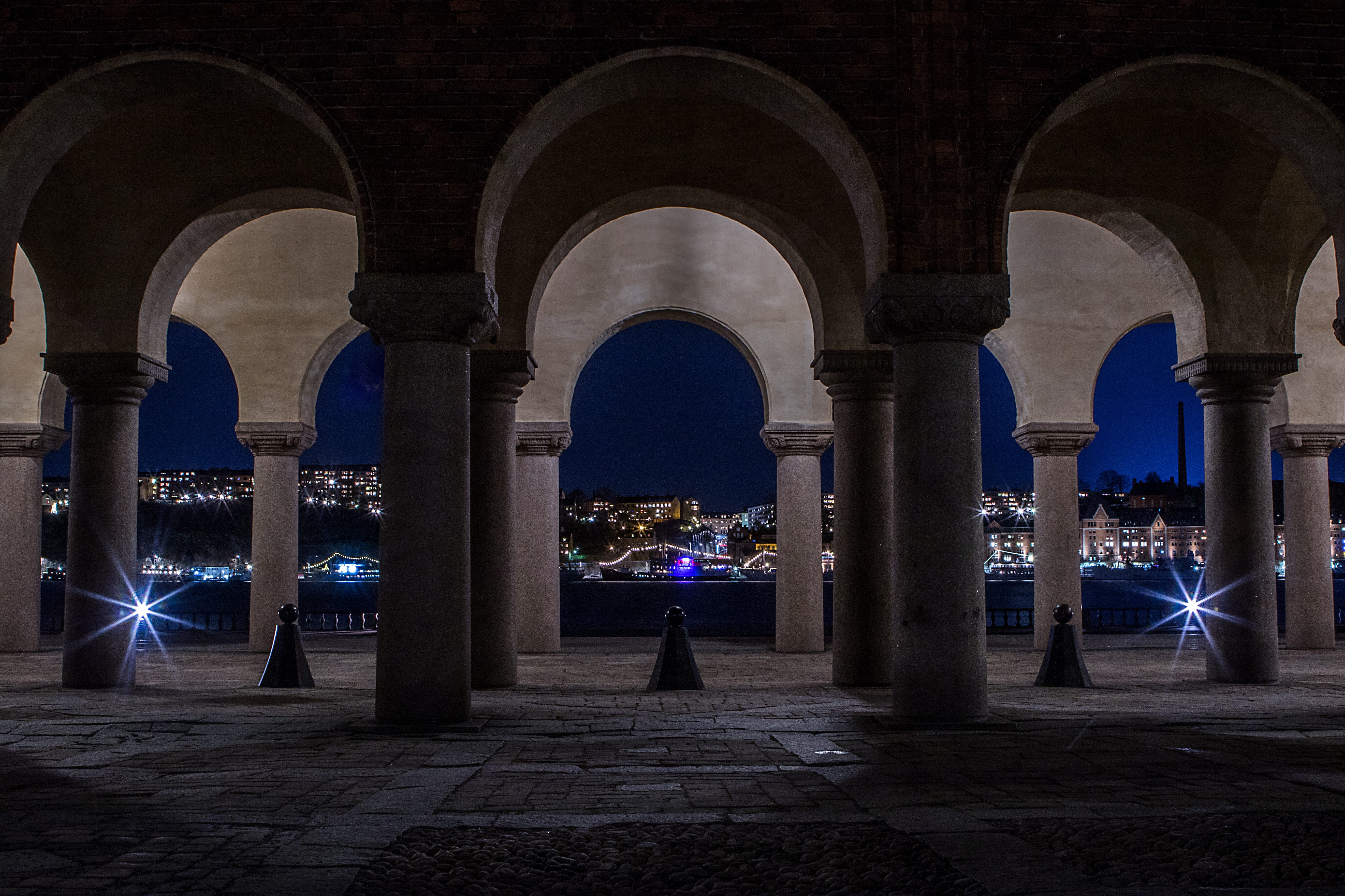 building exterior, illuminated, walkway, column, town, pillar, long expo, outdoors, corridor, light, men, architecture, floor, real people, crypt, architectural column, HD Wallpaper